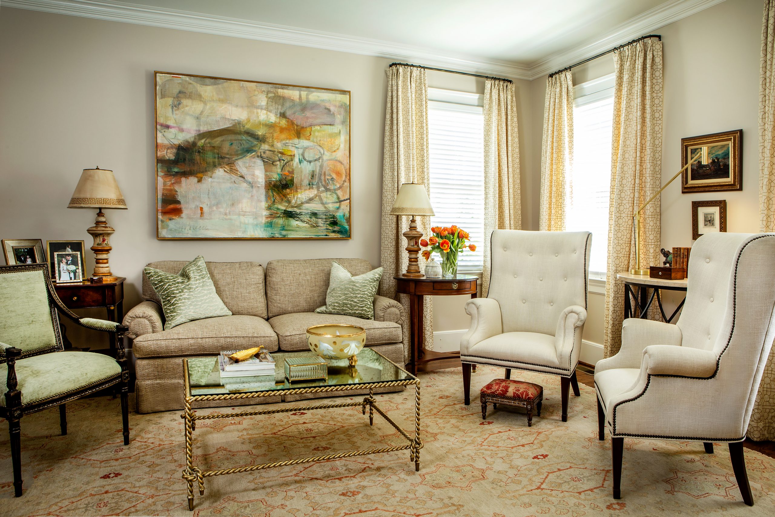 The new living room is Anne’s favorite feature of the renovation, where she enjoys mixing traditional family pieces with contemporary ones. An Oushak rug of soft greens and terracotta covers the floor and an abstract painting by local artist Mike Williams create a calm space for quiet reading and visiting with friends. Flowers by Cricket Newman Designs.