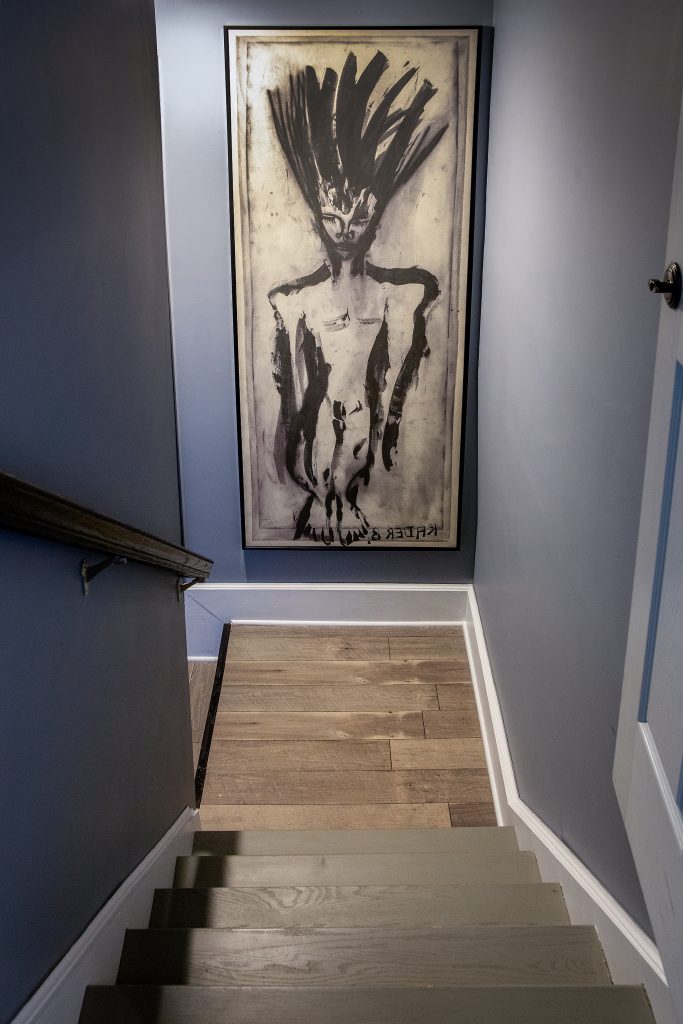 A unique and bold African print purchased two and a half years ago hangs in the staircase leading to the lower level. Artist unknown.