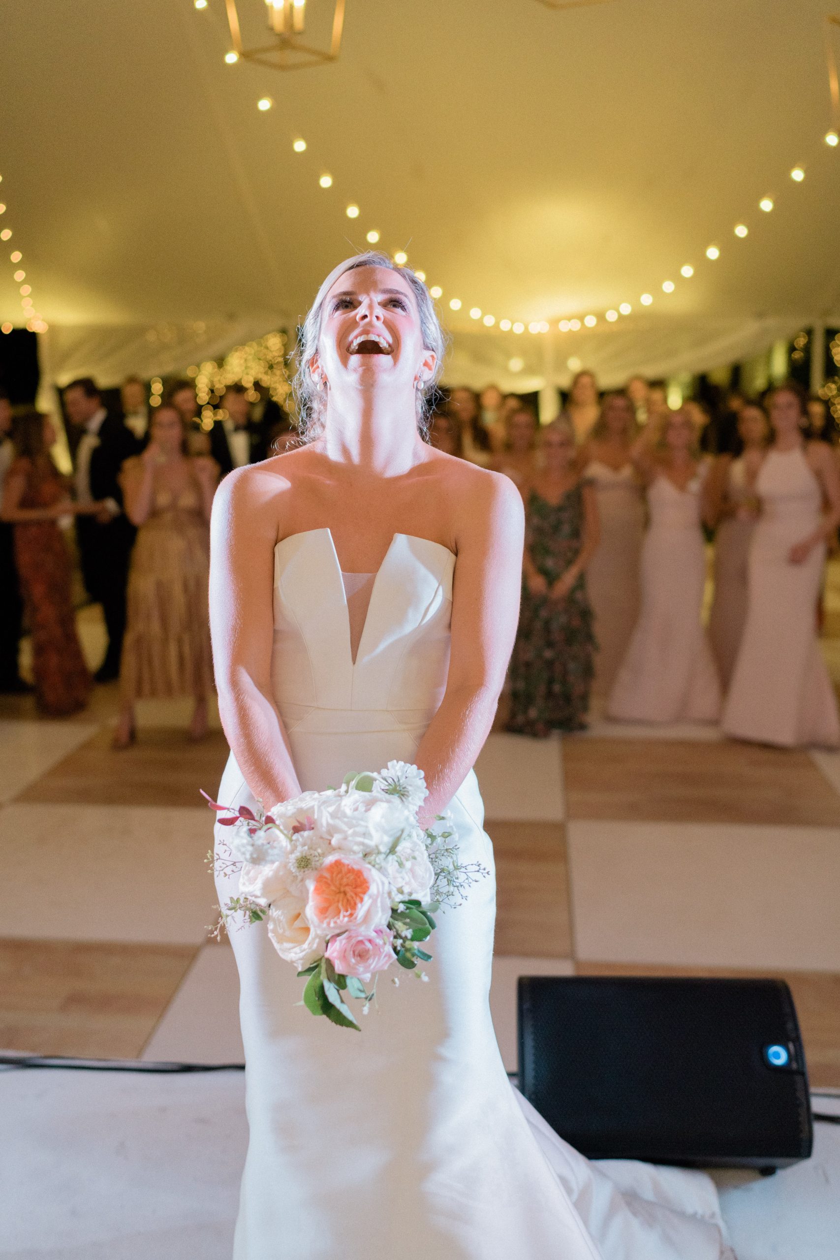 Burgess had to toss her bouquet twice to reach her eager bridemaids. The girlfriend of one of John’s groomsmen made the lucky catch.
