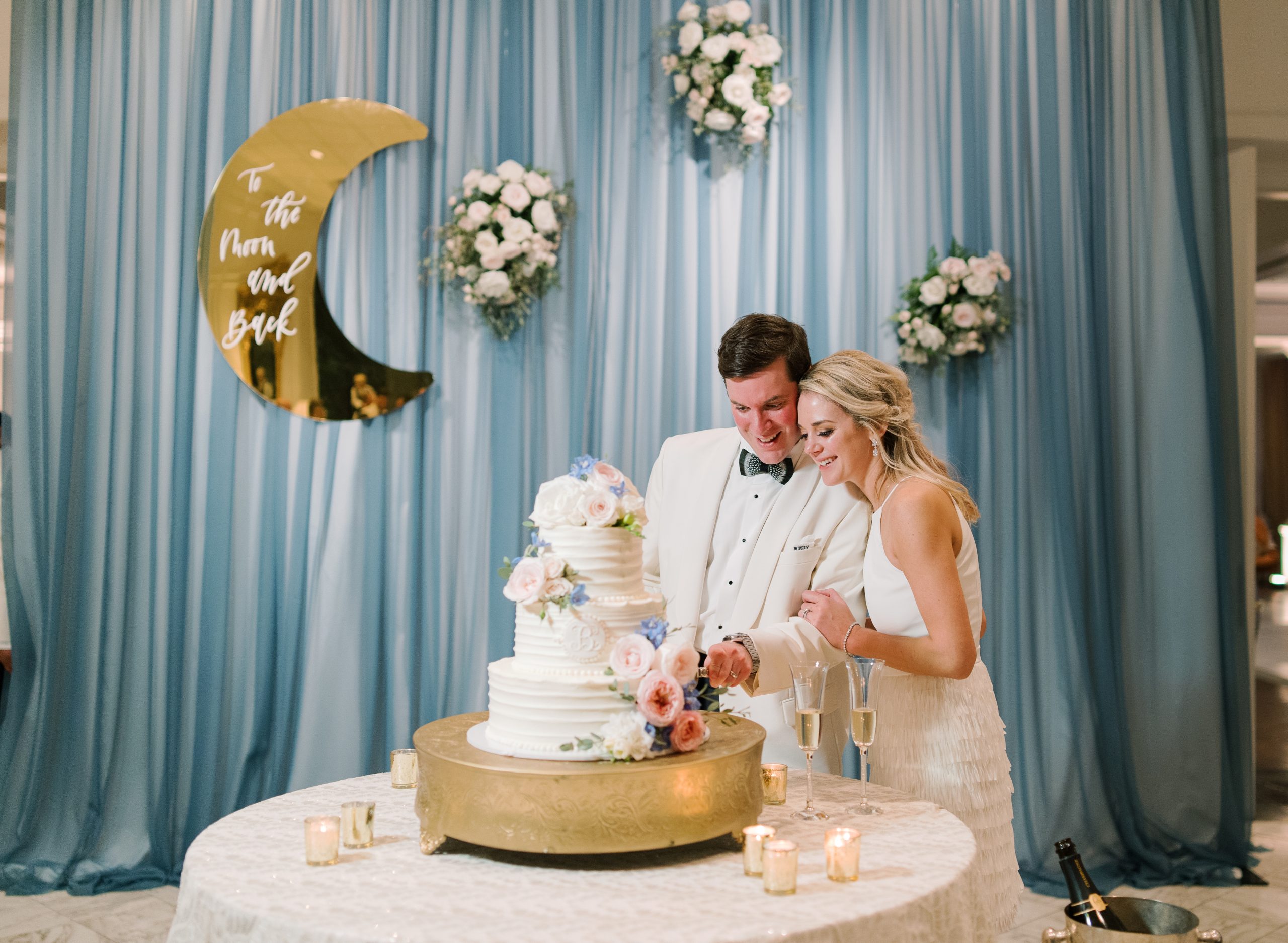 Tiny wedding details were very personal and important to Rustin and Chris. Hung over the cake table was a golden fingernail moon, which was inscribed “To the moon and back,” which the couple whispers to each other many times a day.
