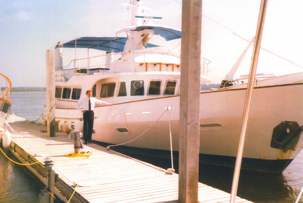 U.S. Attorney Henry McMaster stands next to the Dutch Treat, a yacht owned by queenpin Carol Amend until its seizure by the U.S. government under the then-untested legal tactic of civil asset forfeiture.