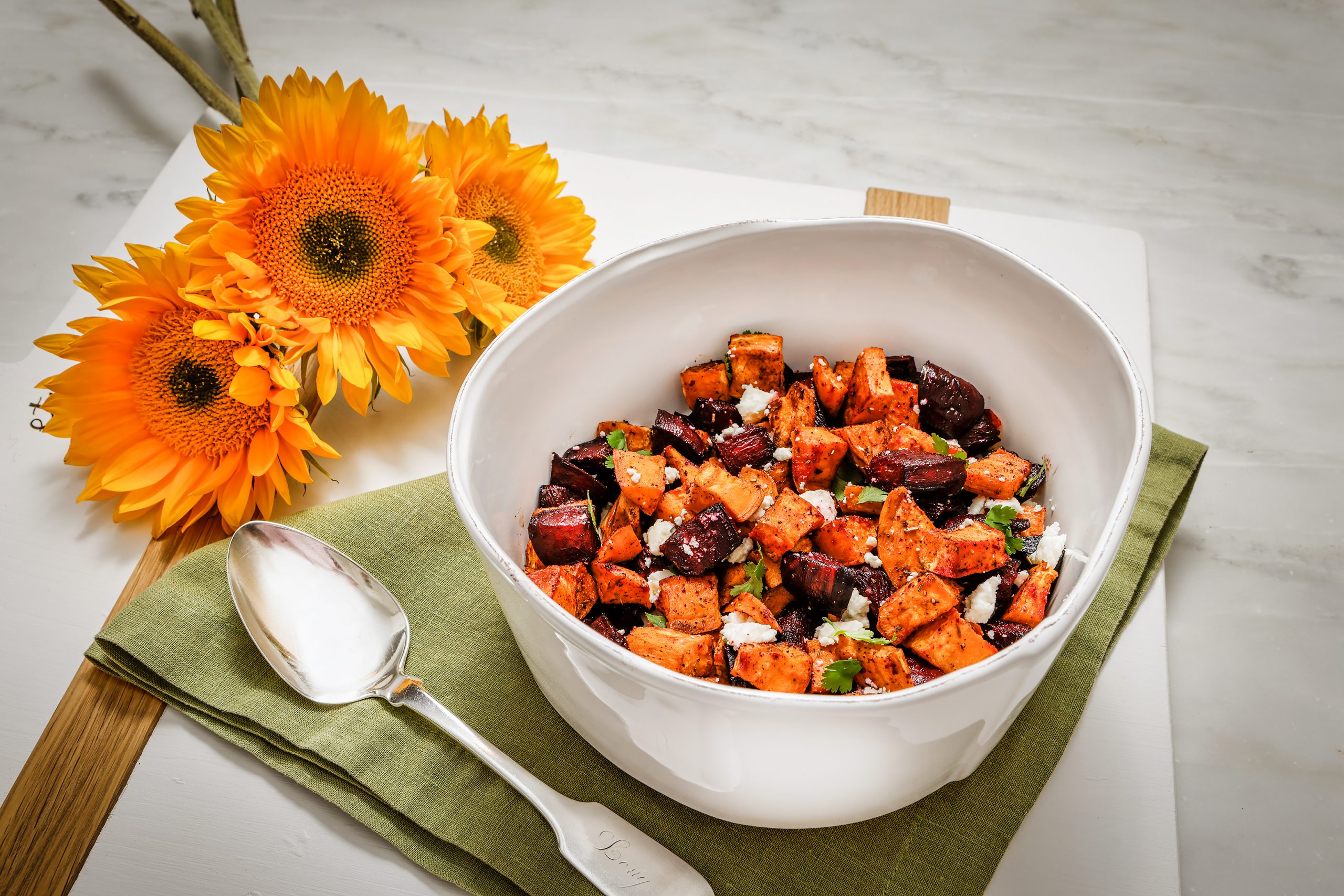 Freshly roasted beets and sweet potatoes are a perfect accompaniment to any fall meal. Add some feta cheese and cilantro for extra flavor. Charcuterie and Serving Board by etuHOME, Lastra White Medium Serving Bowl, courtesy of The Gourmet Shop.
