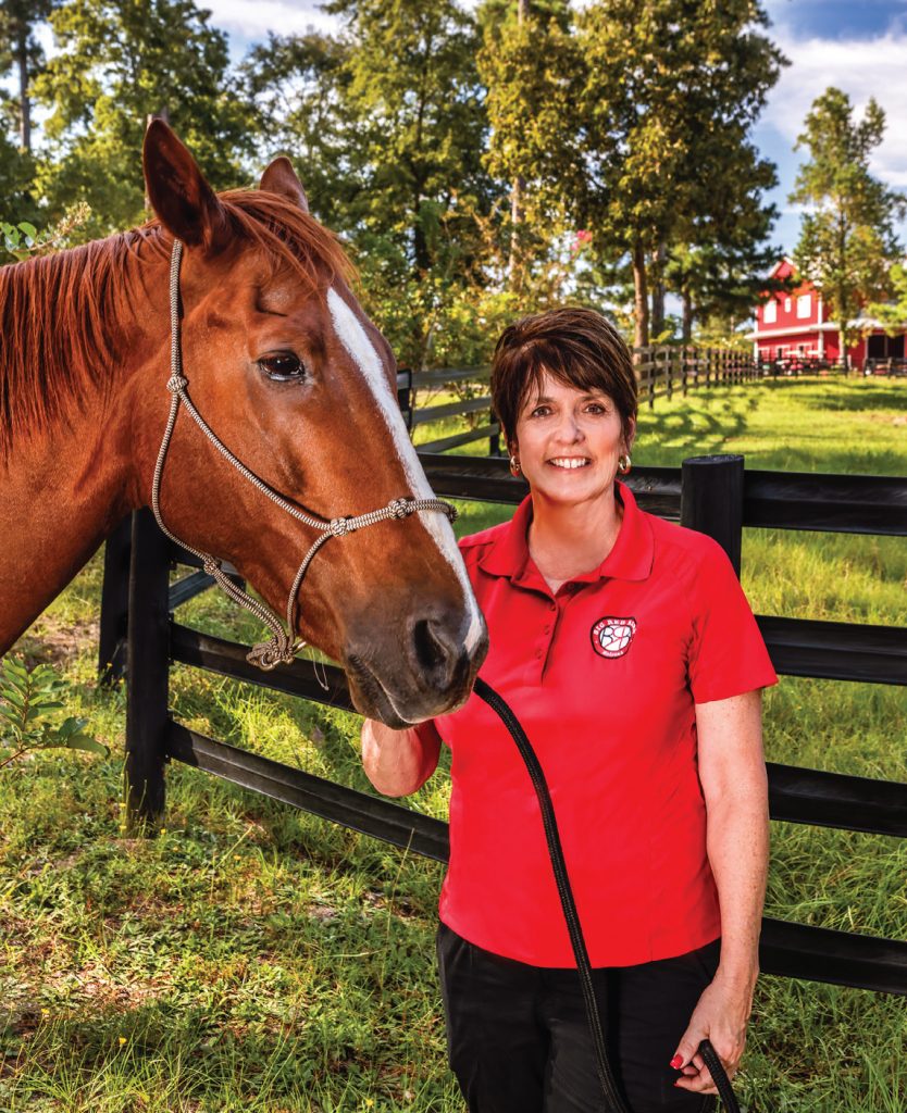 Barbara began to heal from the grief of losing her husband through developing a relationship with her horse. Subsequently, she developed a desire to help others do the same, and the Big Red Barn Retreat began offering equine-assisted therapy. Sutton Shaw poses with Calypso.  