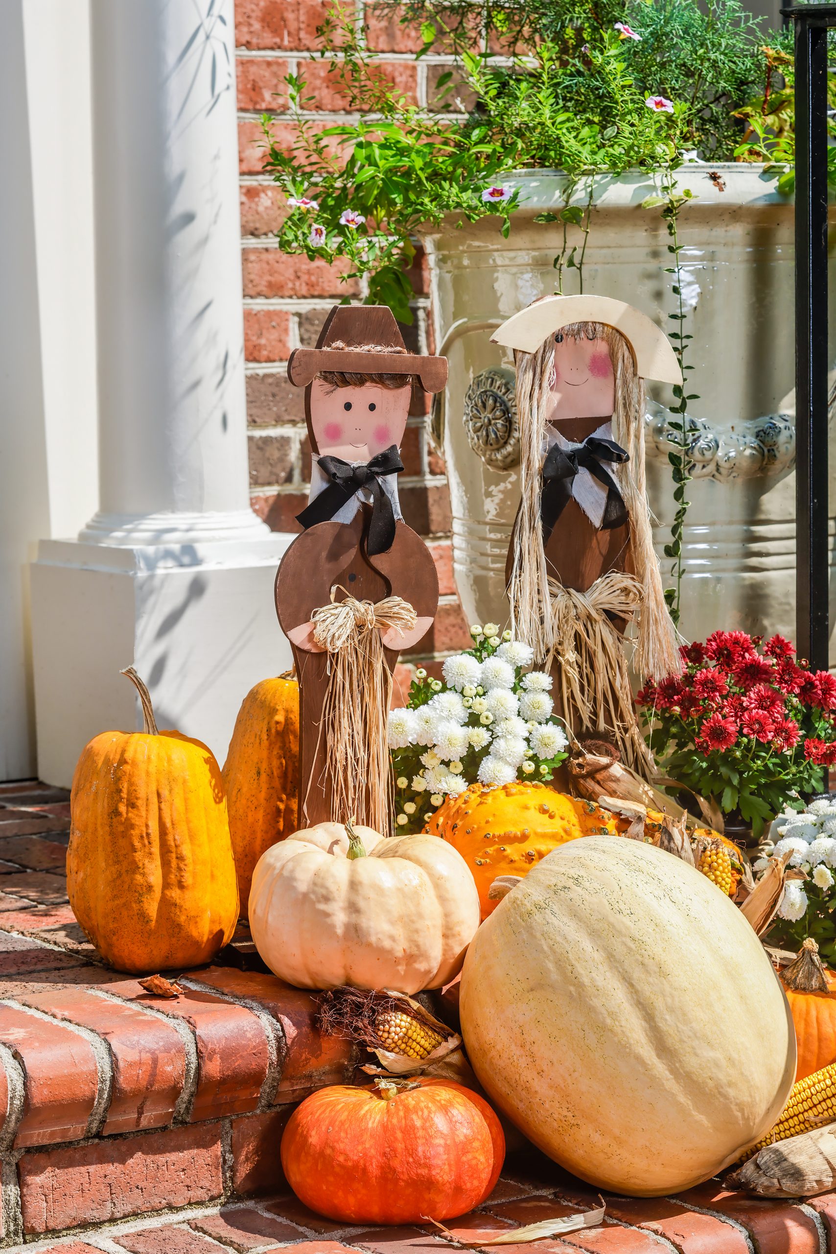  The entrance is a wonderful place to arrange traditional Thanksgiving decorations, like Pilgrims, colorful gourds, Indian corn, hay bales and potted mums — all easily collected and assembled. Repetition is good and highlights the reason for gathering!
