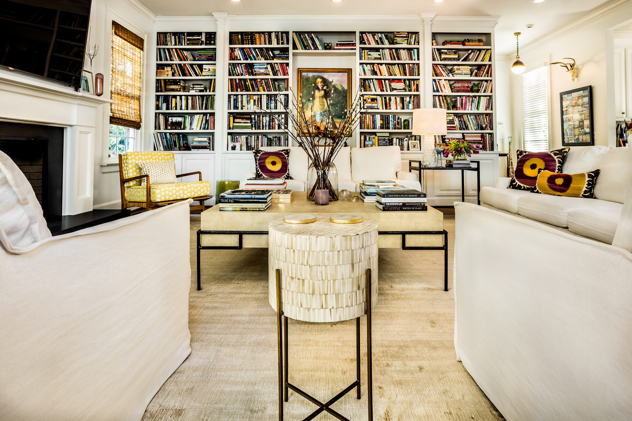 Karen’s aesthetic has evolved over the years, and she has lightened and brightened their home to accommodate gracious space for living and entertaining and their ever-growing and changing collection of artwork and books. Their kitchen was formerly adjacent to a double den with two rooms divided down the middle by a wall with a fireplace and built-in bookcases. It was renovated five years ago into a beautiful large, open space that is perfect for entertaining and family gatherings spilling onto the lovely terrace.