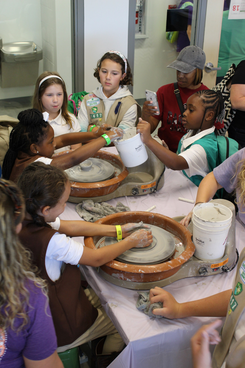 Girl Scouts hone their wheel throwing skills in the art studio at the Cathy Novinger Girl Scout Leadership Center.
