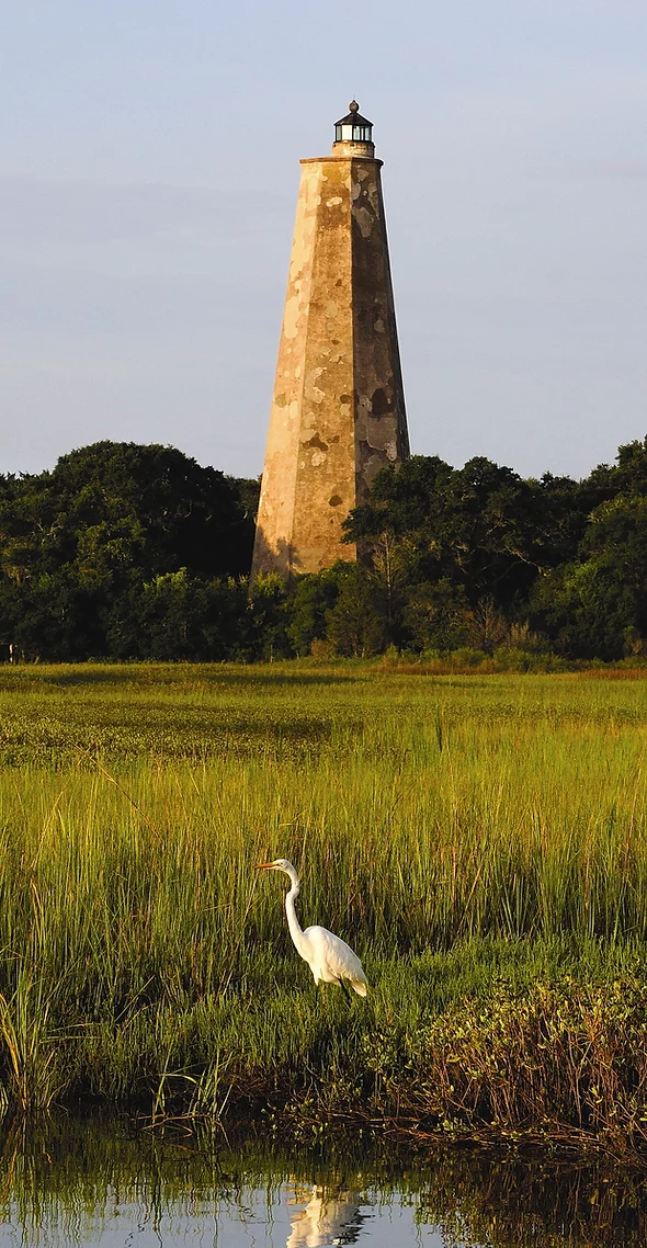 Old Baldy Lighthouse was completed in 1817 after erosion decimated its predecessor. The 110-foot walls consist of bricks covered with stucco as protection against the elements. Visitors can climb the 108 stairs for breathtaking views of the Cape Fear River estuary. 