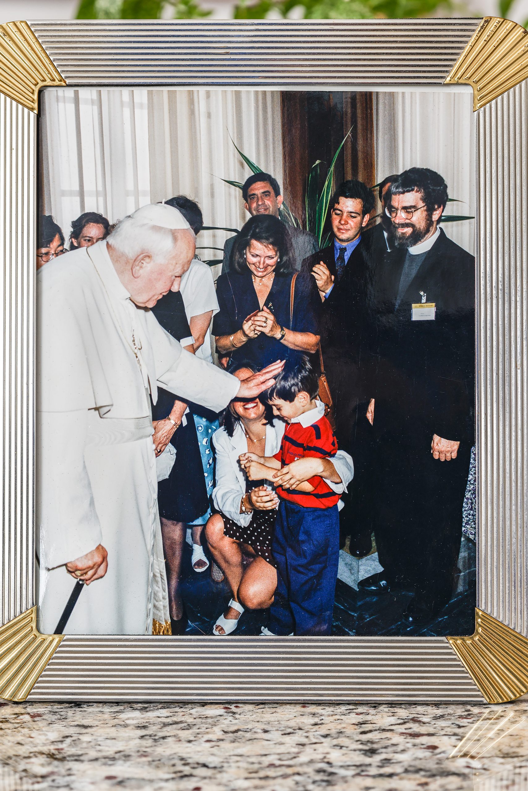  Pope John Paul II blesses their youngest son, Francesco, at 8 years old. Eligio was on the board for the Vatican Observatory, an astronomical research and educational institution supported by the Holy See, and the board had been invited for a special audience with the pope. The Maolis were the only lay people as everyone else was either a nun or a priest. John Paul II was known for walking away from the adults in a gathering to seek out children. Paola says that as soon as he saw Francesco, the only child in attendance, he zeroed in on him and gave him his blessing. 