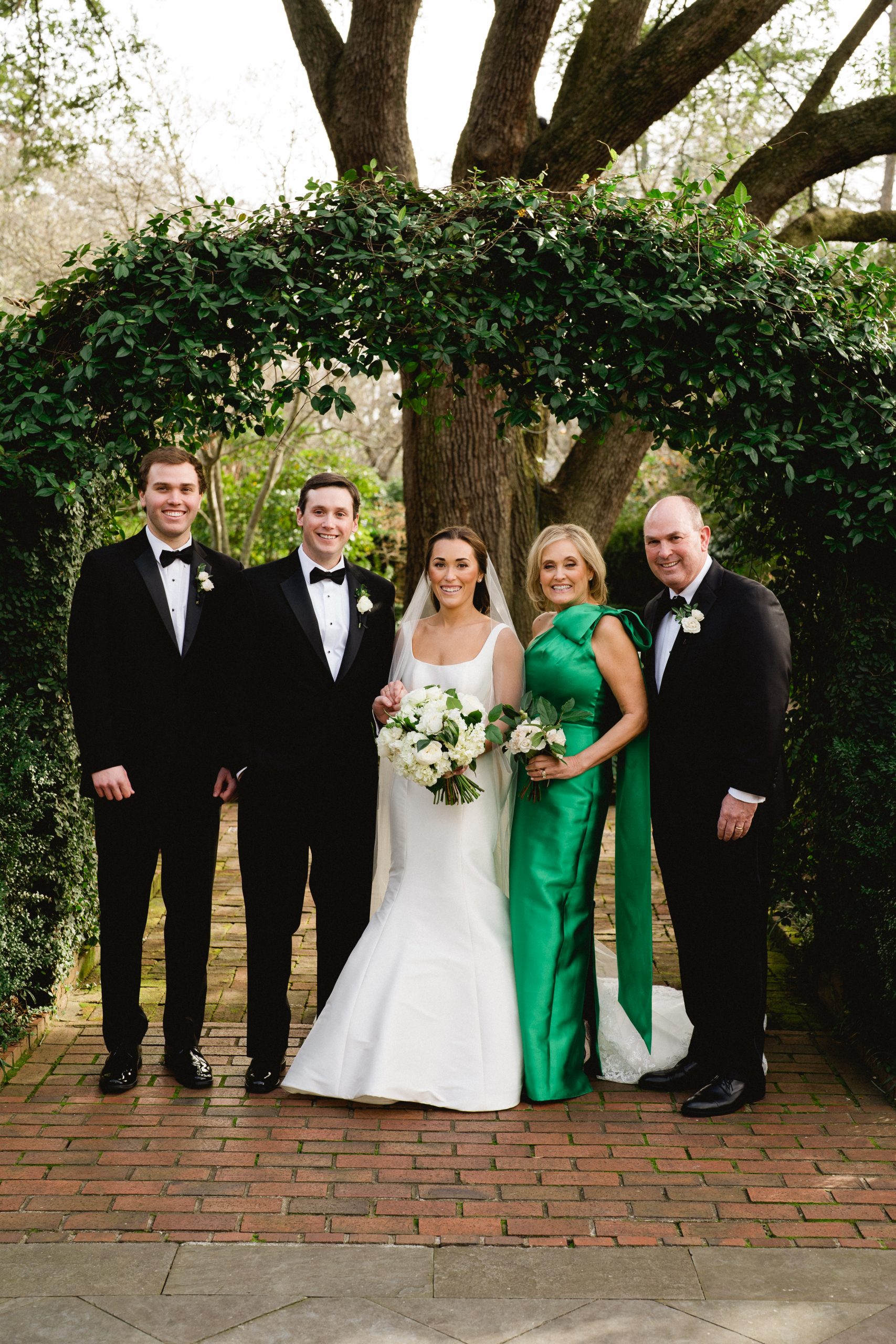 Mimi’s brother, Christopher; Jack and Mimi Collins; and Mimi’s parents, Jan and Chris Marshall. Mimi’s beautiful dress was designed by Sareh Nouri, and her veil was custom-made by Sassi Holdord from London. 
