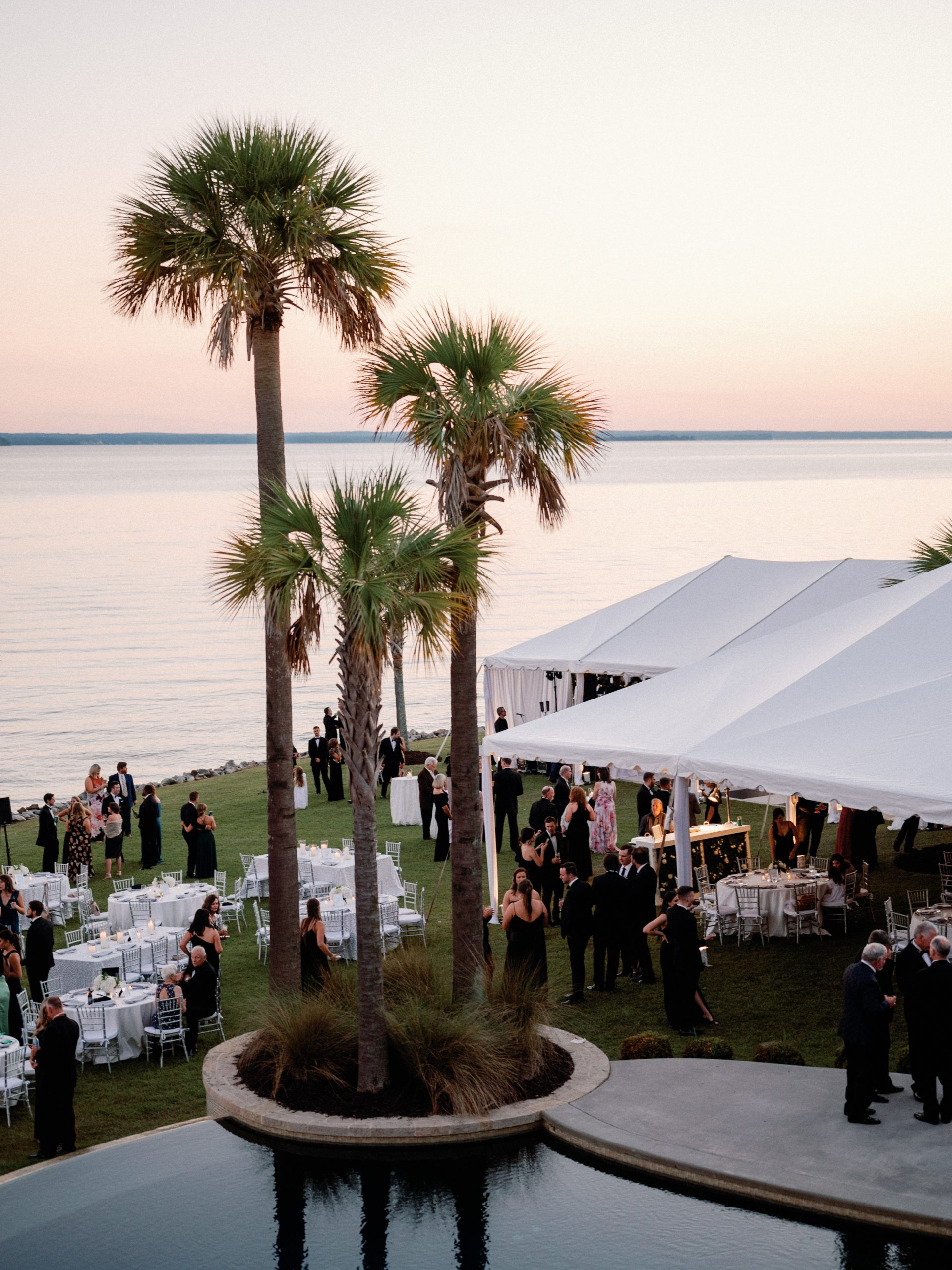 Jordan insisted upon having seating for every guest, and white roses and candles graced each table. Lakeside tents were magical with lush bouquets hanging from the chandeliers over the dance floor.
