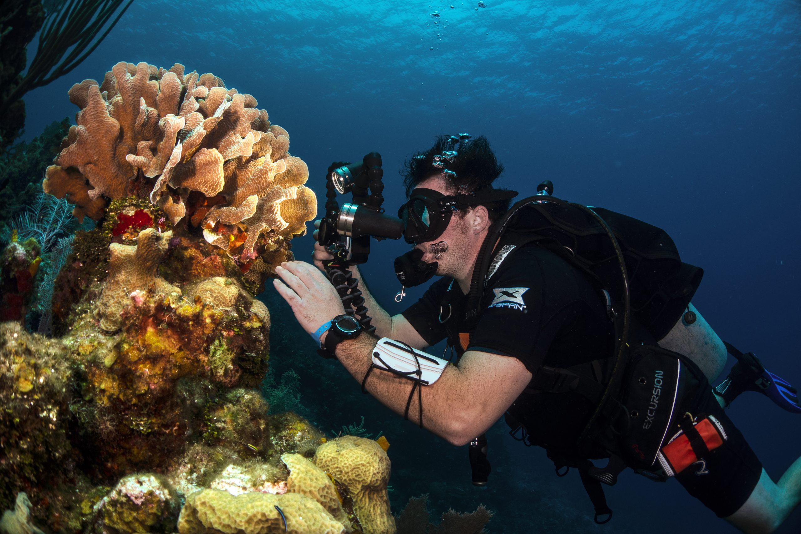 The author’s son, Joseph Walker, films coral on a dive in Roatán, Honduras, using the latest technology and equipment in underwater exploration.