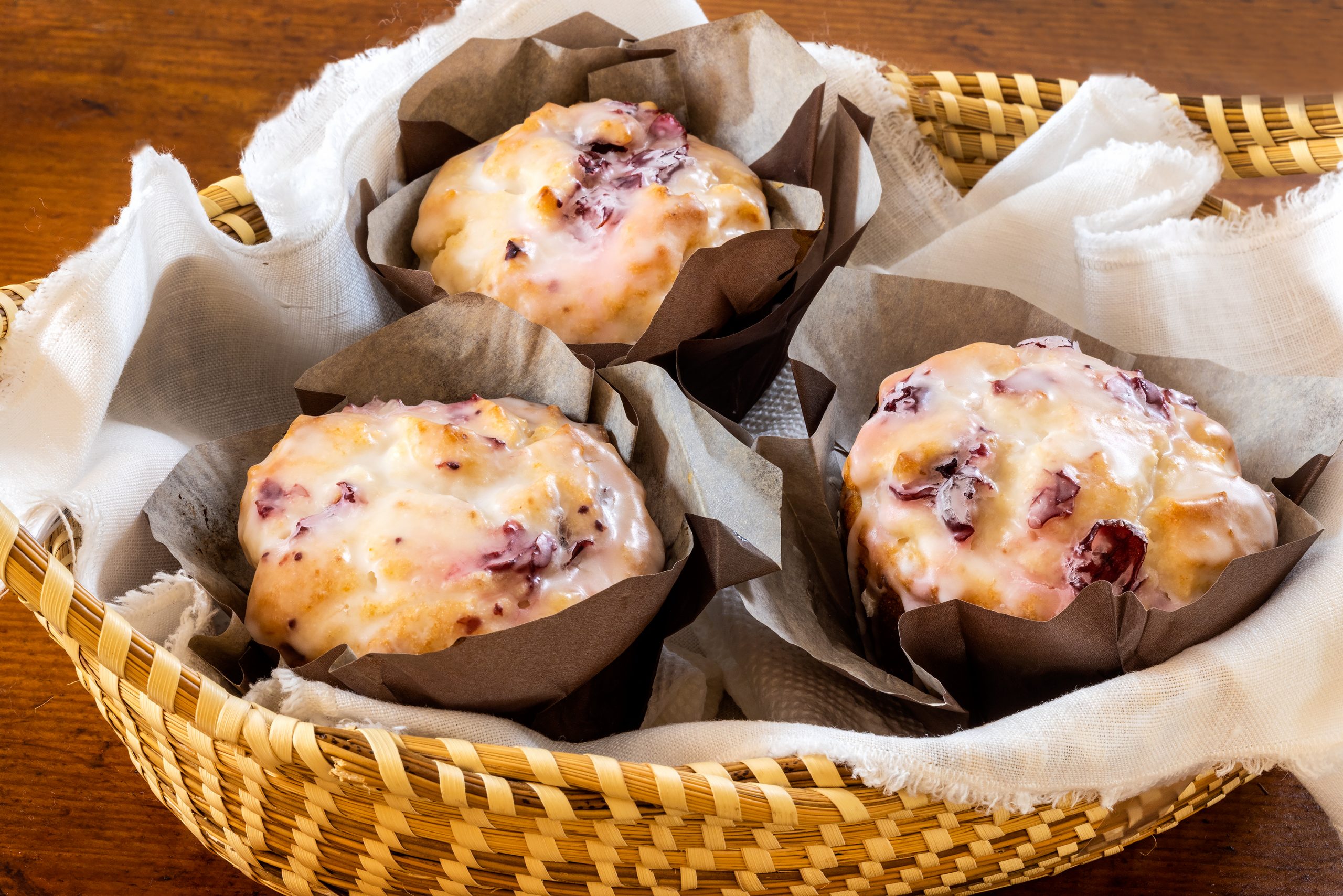 Glaze adds the final sweet touch to almost any muffin; use different liquids to vary the flavor and richness. These cranberry muffins, with a glaze, are served in a sweetgrass basket on a French cheese board, courtesy of McIntosh Cottage Antiques.