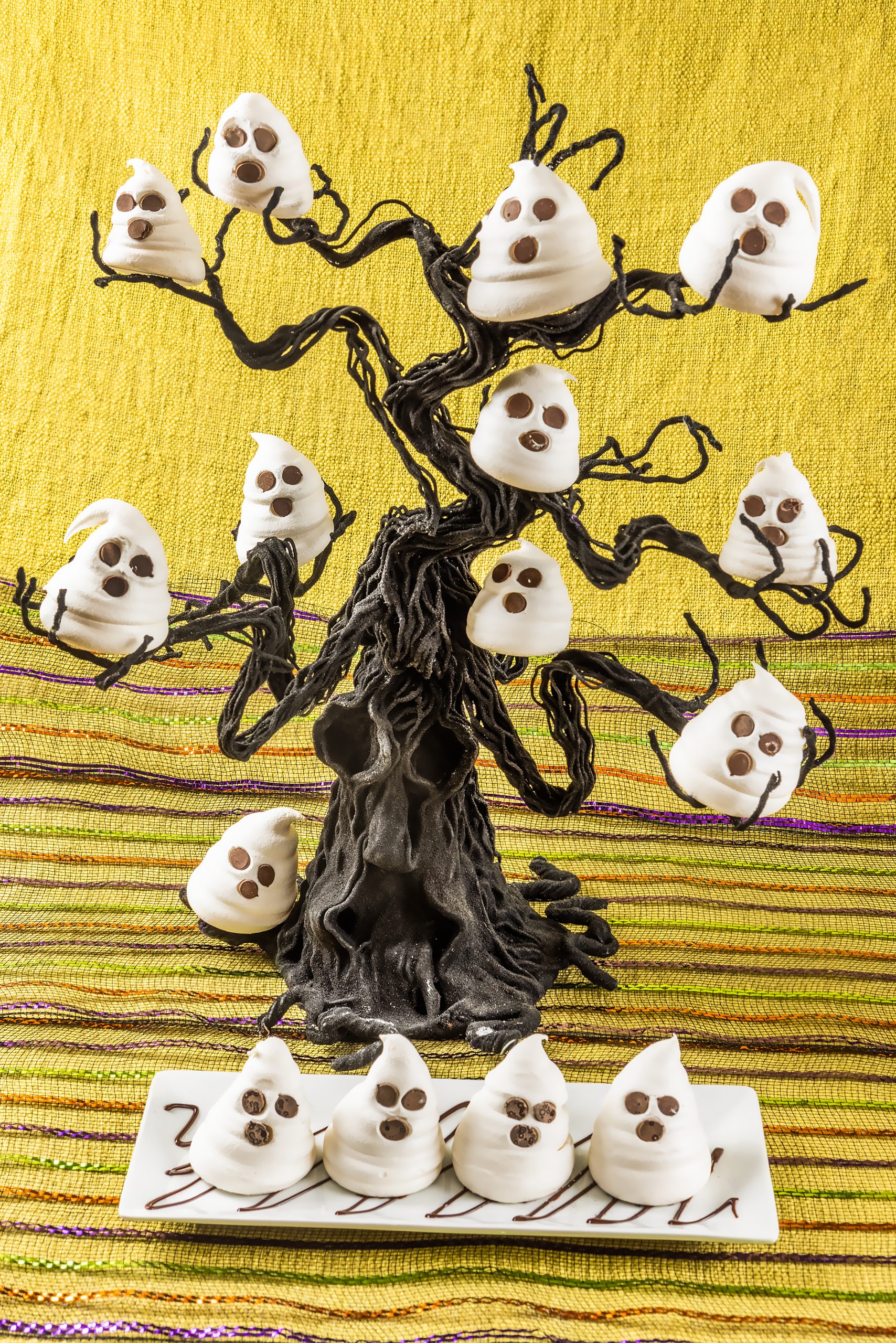 Finish your smashing Halloween dinner with frightfully delicious meringue ghosts. Creative Co-op tablecloth courtesy of Kudzu Bakery & Market.