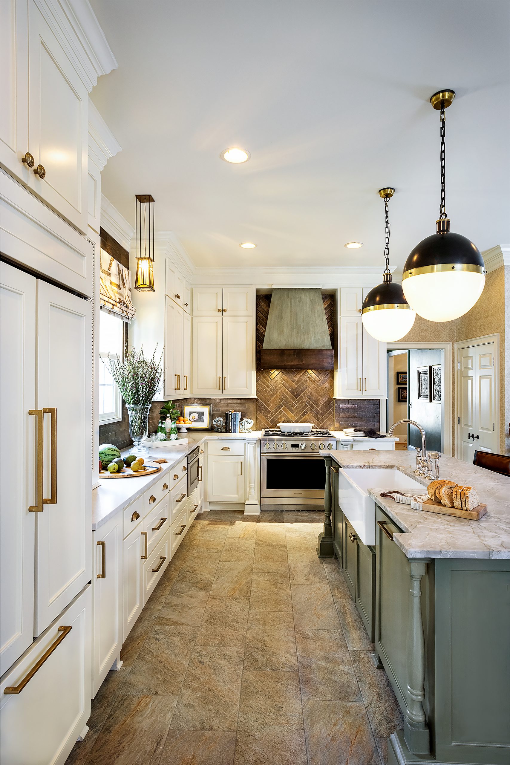 Cathy, a marvelous cook, loves the warm inviting kitchen with impressive appliances, stylish pendant lights, quartz countertops, and copper backsplash. Cathy and Cal enjoy incorporating generational pieces into their design.