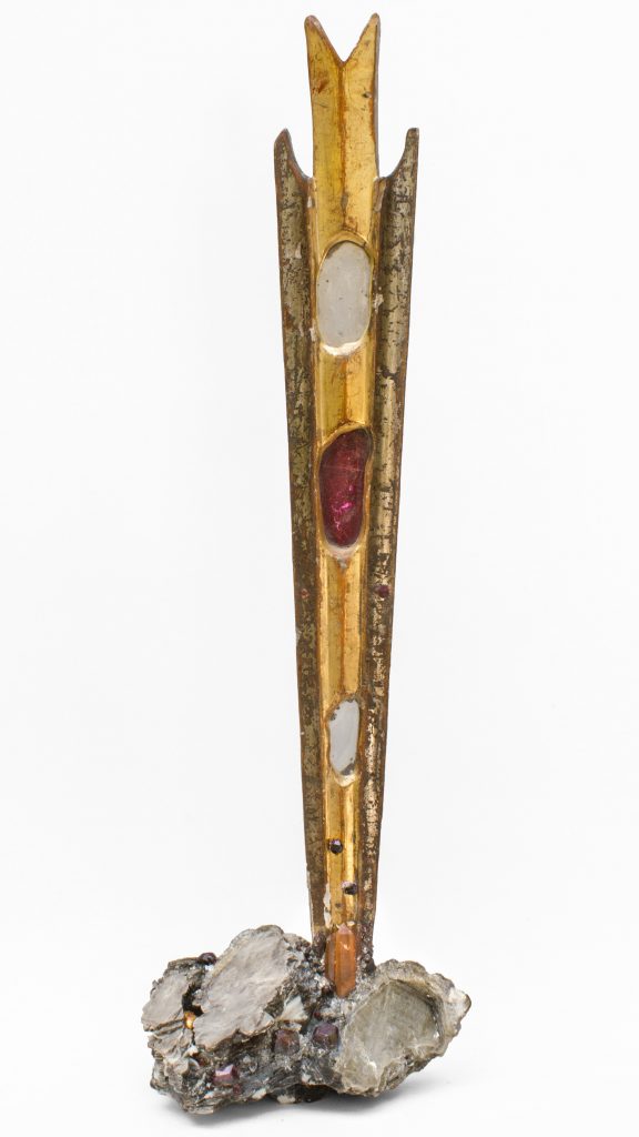 Eighteenth century Italian sunray with gold and silver leaf with inserts of antique mirror and stained glass on a coordinating mica base encrusted with garnets. 