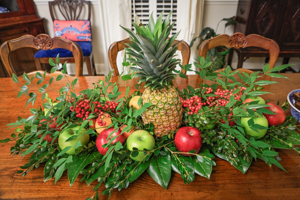 Elizabeth’s parents used centerpieces made from fruit and lush Christmas greens that lasted all season. Elizabeth continues the tradition by arranging oranges, apples, lemons, limes, and pineapple with holiday greenery on decorative boards given to her by her father. 