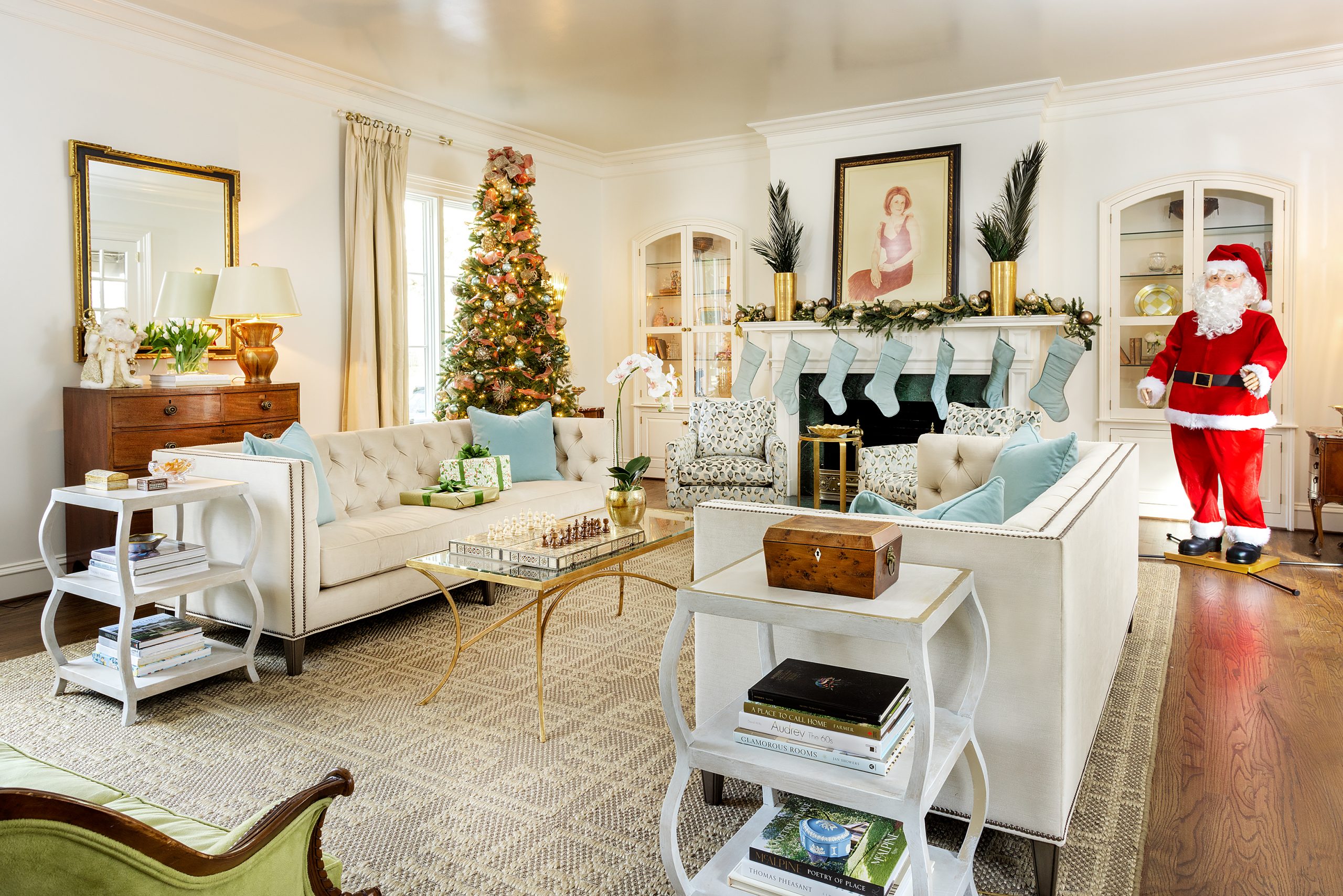 Though Elyse was able to incorporate most of the furniture from their Gregg Park home, the cool neutrals that she and Rossi selected gave them the opportunity to rethink the home’s holiday decor. The Christmas tree is surrounded by a pale blue skirt and stockings that mirror the accent fabrics used throughout. During the holidays, a surprisingly realistic, full-sized Santa Claus supervises the awed grandbabies! 