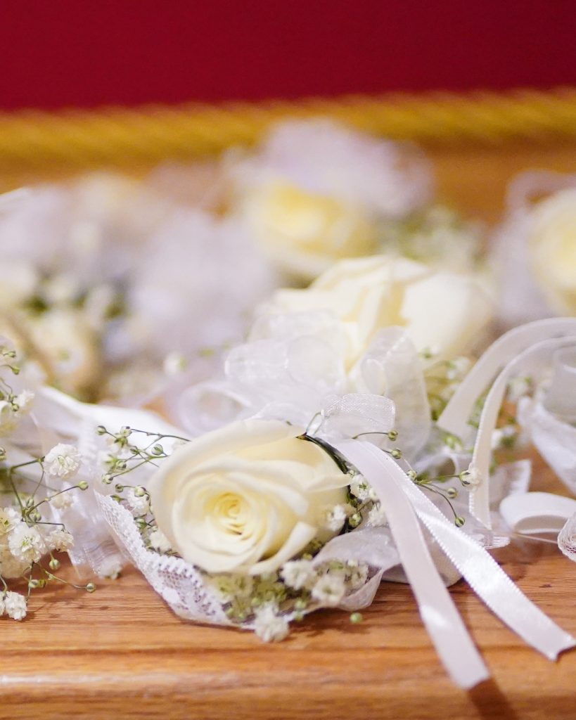 White bouquets and boutonnieres were designed by Cricket Newman Designs. 