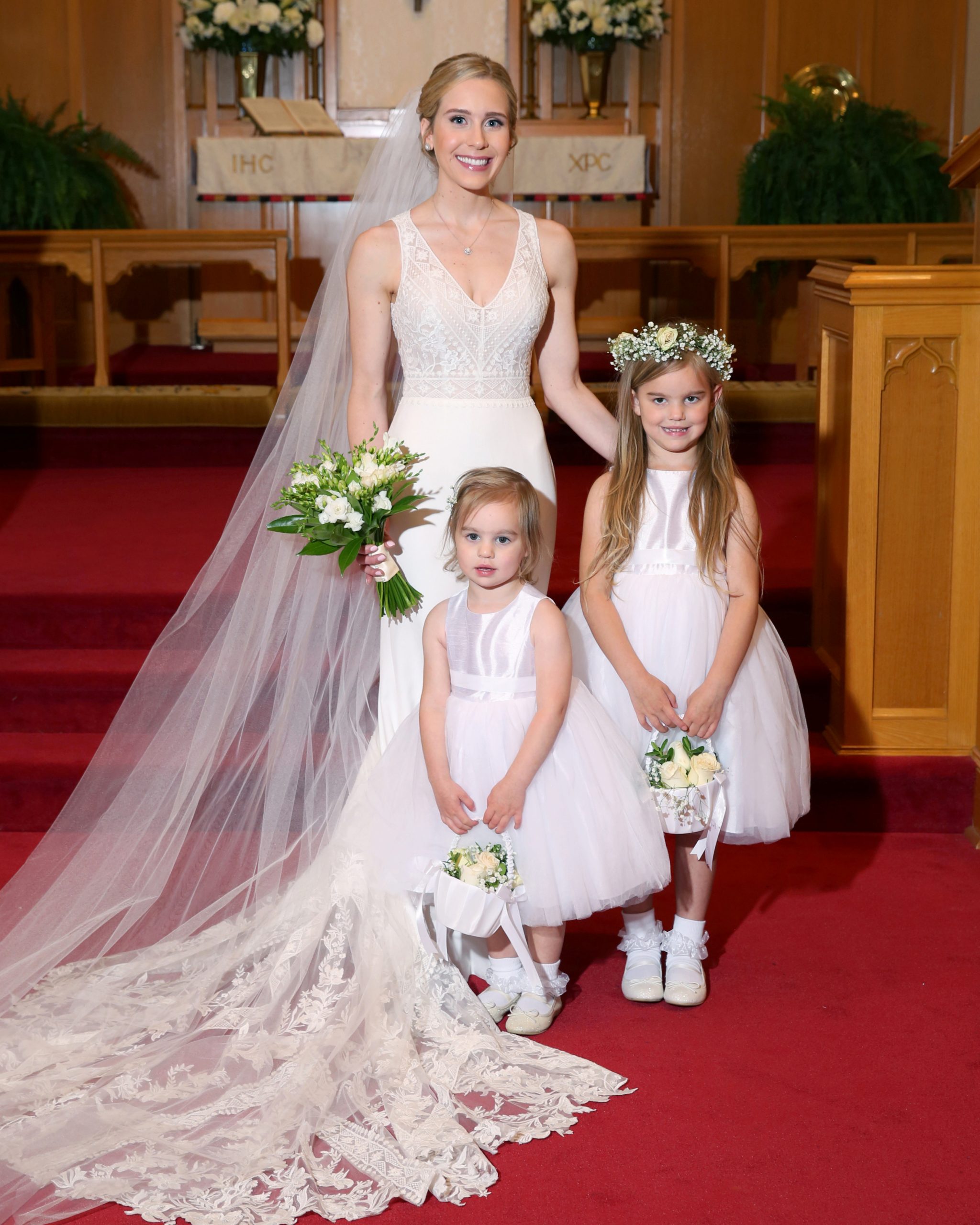 Natalie with her flower girls, her nieces Ella and Payton Richardson. The girls carried baskets of white flowers, while Natalie carried a bouquet of freesias. 