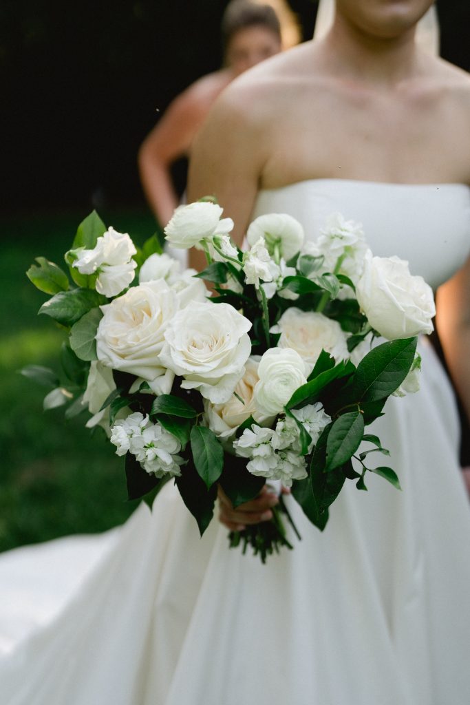 Olivia’s bouquet included white roses, sweet peas, white stock, and salal. 