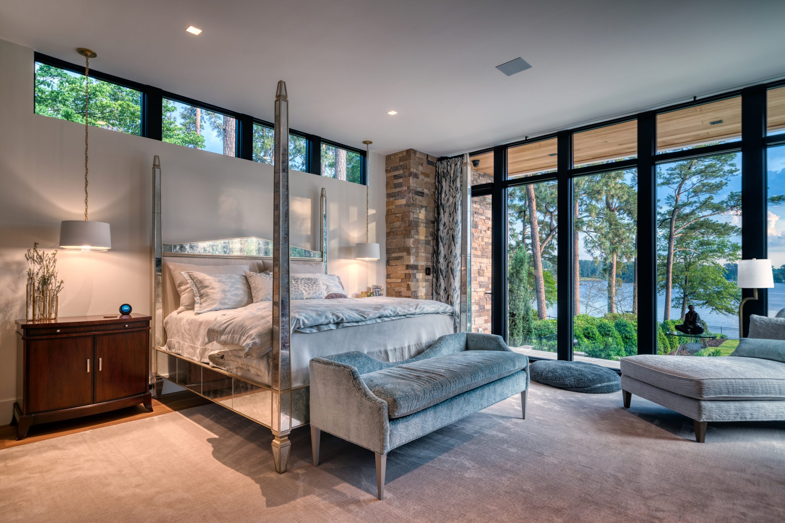 The master bedroom on the ground floor has a beautiful view of the lake and a stunning four-poster Venetian mirrored glass bed. A wide bench is what Kay calls Cleopatra and Jax’s launching pad to her bed, one of their favorite places in the house. 