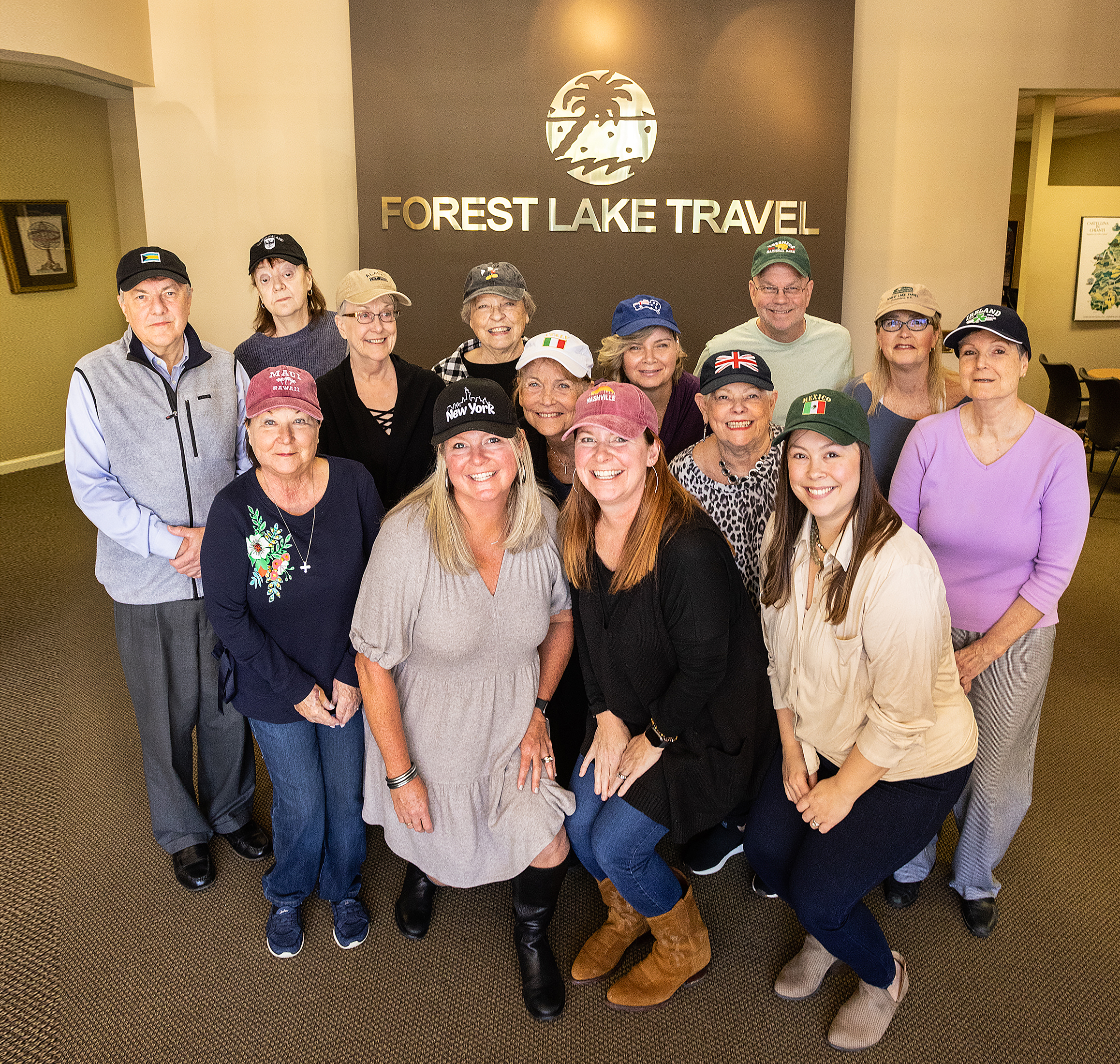 Voted Best Travel Agency, Forest Lake Travel tips their hats to your destination! Back row: Donald, Monika, Lynn, Nancy, Deborah, Shelley, Mary, Rocky, Terrie, Jane. Front row: Margaret, Katie, Marilyn, Daisy.