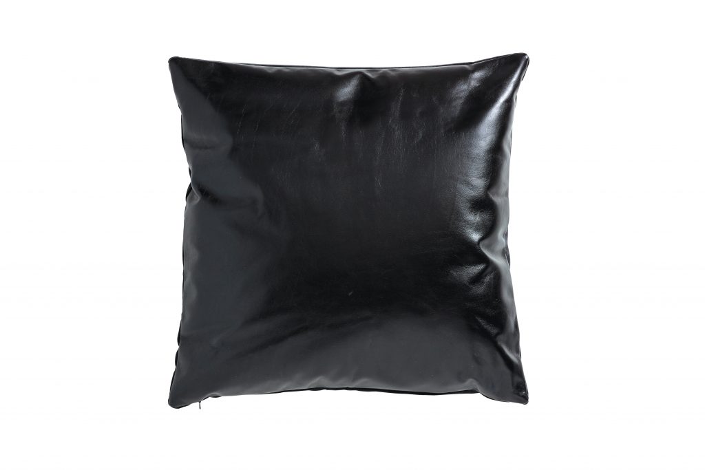Pillows in a variety of textures, like leather, add visual interest that makes small spaces feel homey.