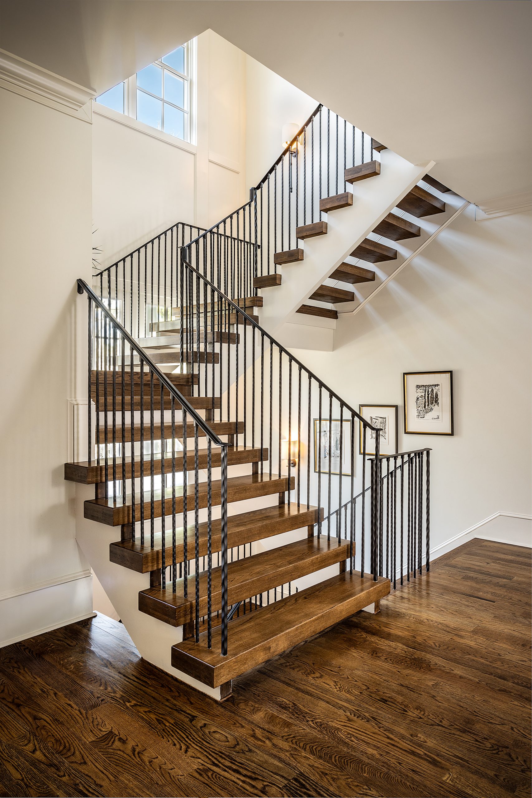 The three-story stairway adds architectural interest and juxtaposition of angular elements to the design of the home.
