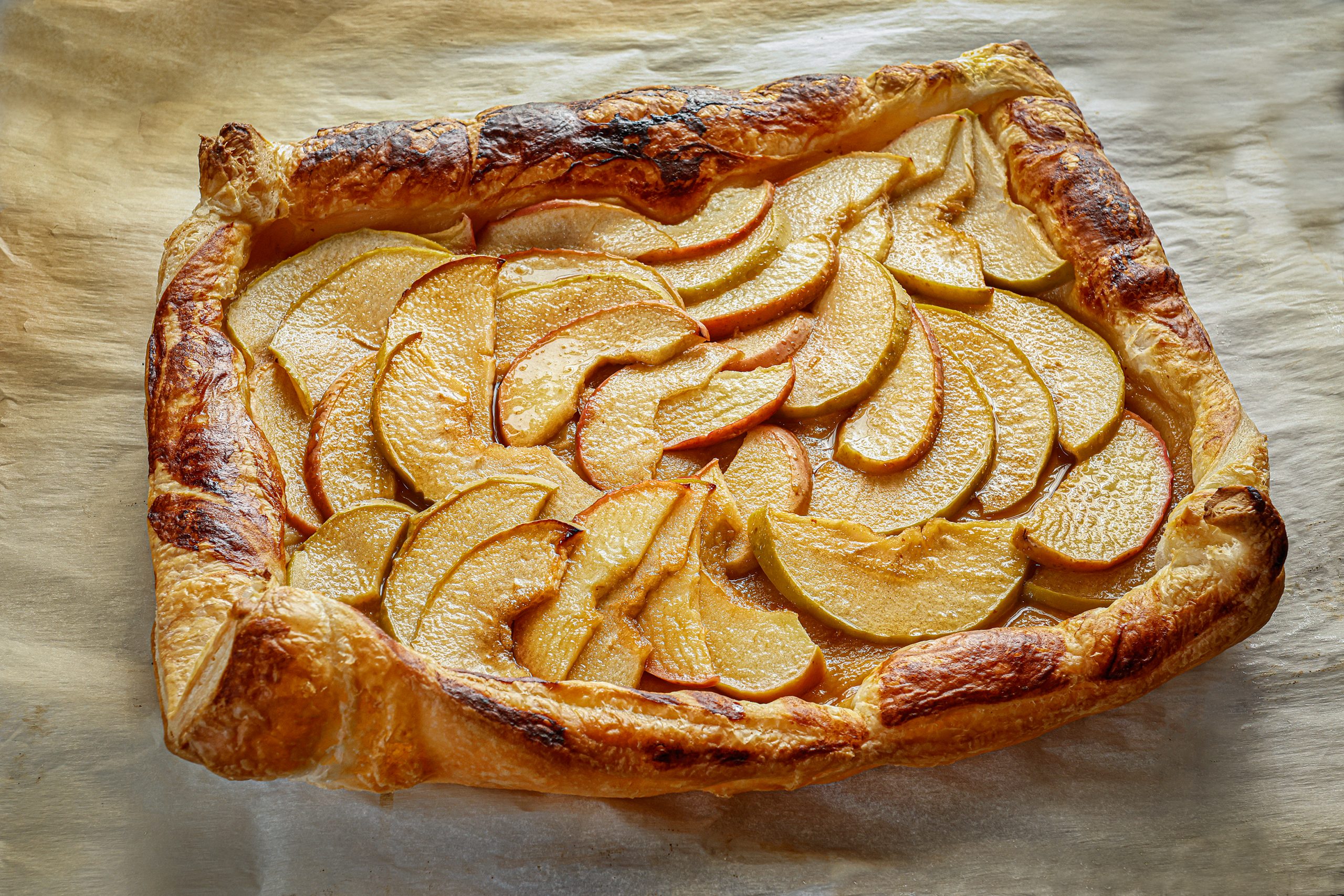 The Simple Apple Tart is deceptively easy and so delicious with the simplicity of buttery, flaky pastry, and sweet tart apples. Using store-bought puff pastry, you can prepare a quick, low-labor dessert that will impress your guests. Substitute pears, peaches, or plums for the apples as the seasons and menu change.