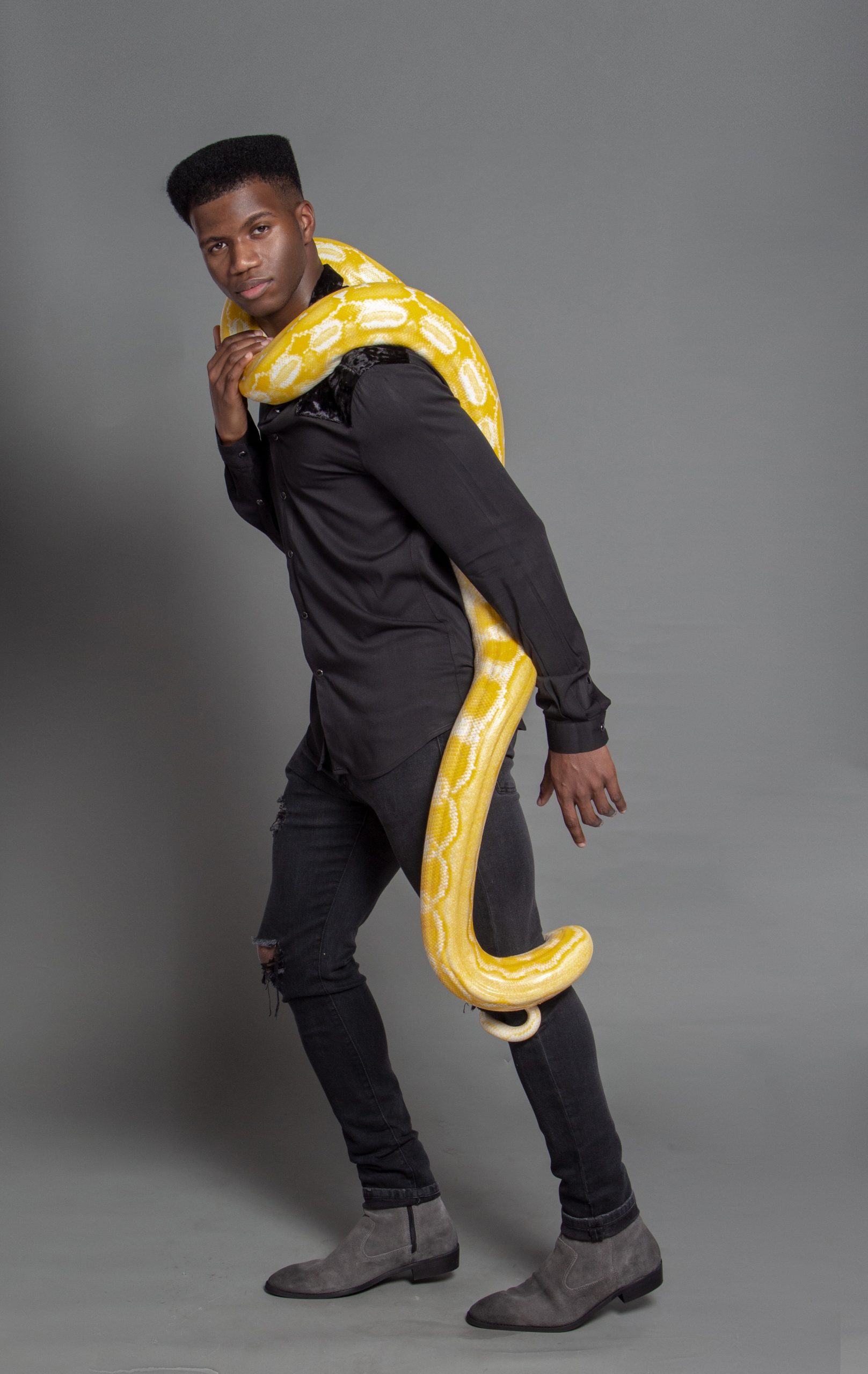 Lee poses with a live albino reticulated python. His work mostly triangulates between Columbia, Atlanta, and New York City — with the occasional excursion to Los Angeles or Paris. 