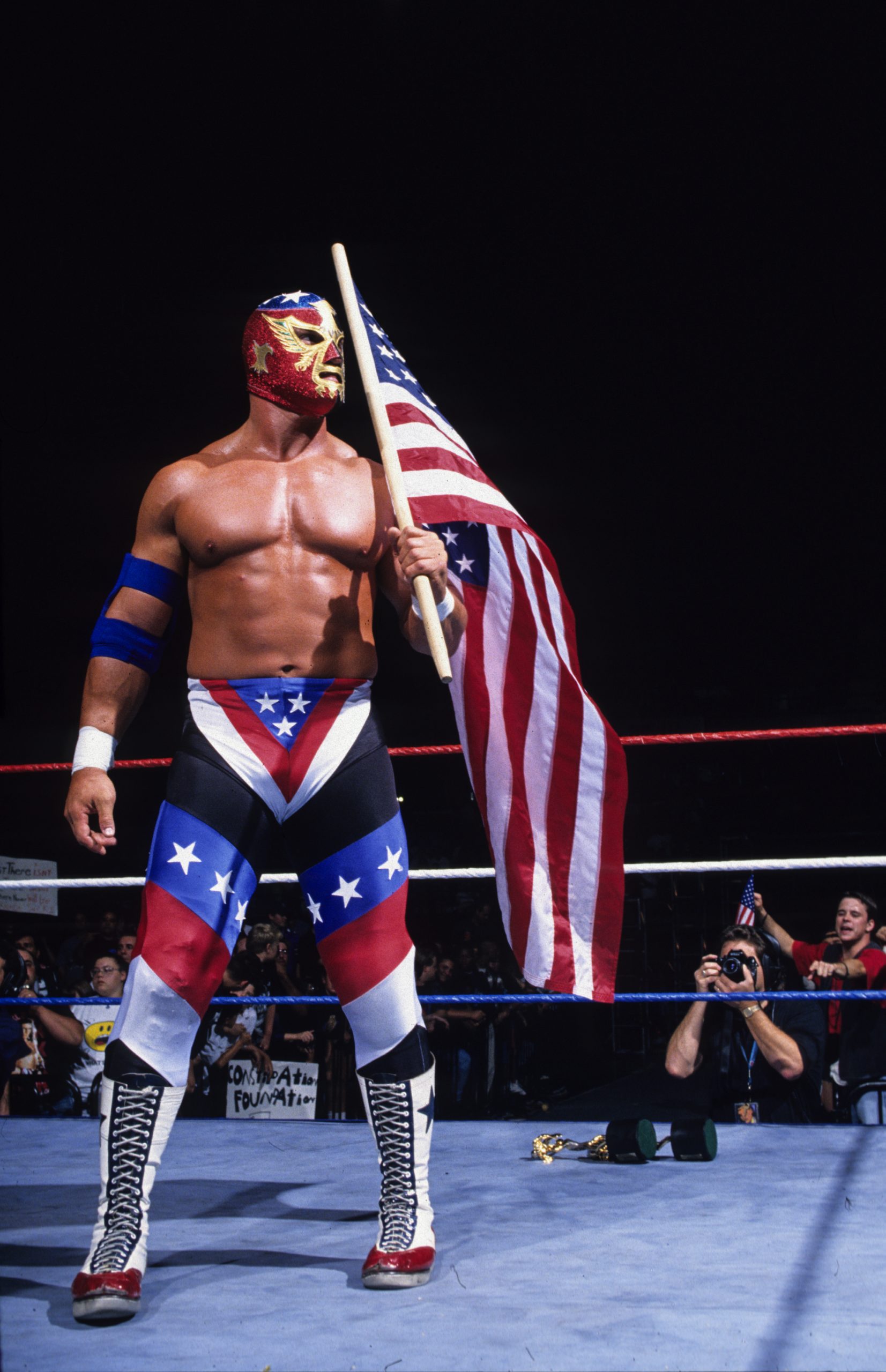Global Wrestling Federation fans learned in the 1980s that Del Wilkes’ character, “The Patriot,” was much more than just a flag waver. Del put his deep, booming voice to great use on the microphone, speaking eloquently and passionately about his love for his country. His chiseled 6-foot-2-inch, 275-pound figure certainly looked the part of a larger-than-life professional wrestler. 
 Photography courtesy of WWE