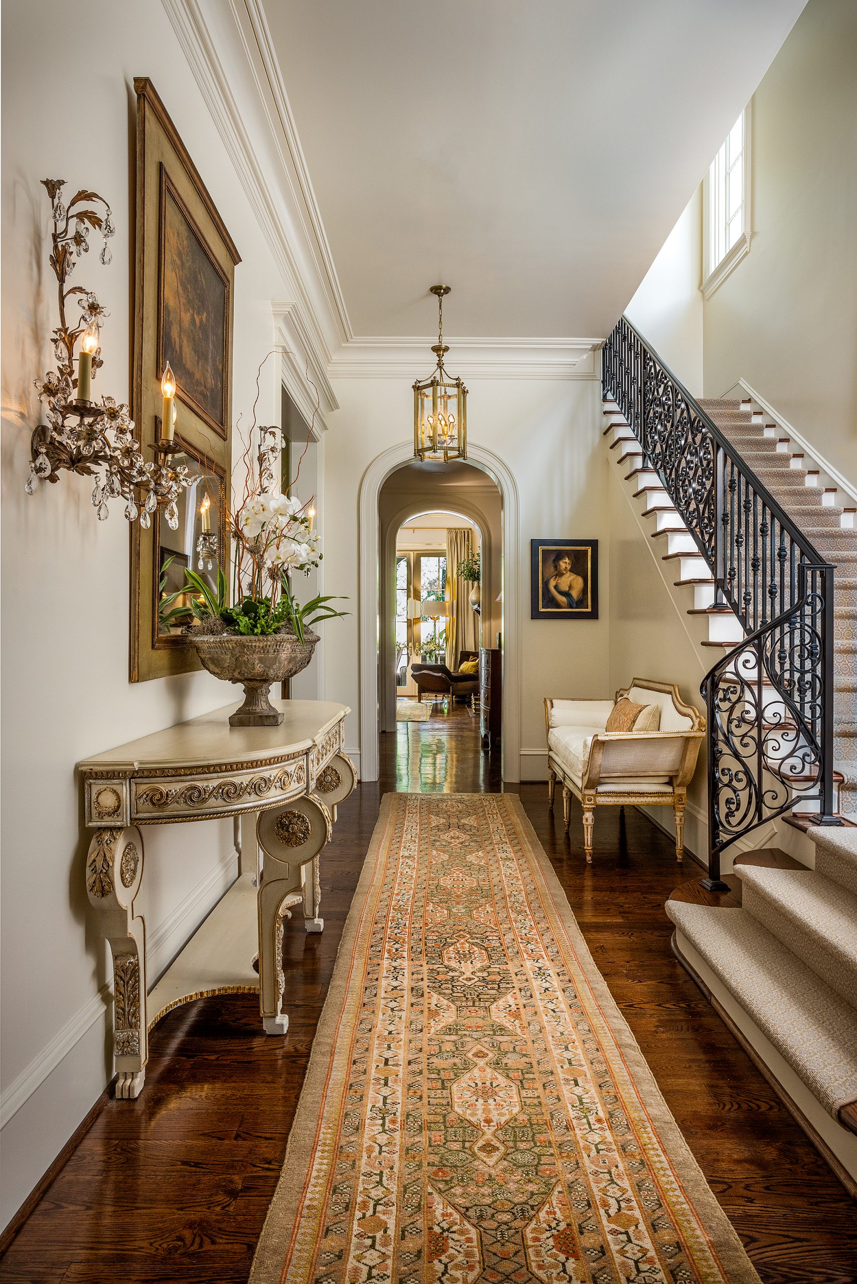 Arches are a significant design element throughout the house, and the gracious 12-foot ceilings enhance their beauty. Using a design Marion had admired, Archie Owens of Owens Welding created the unique wrought iron interior staircase railing. 
