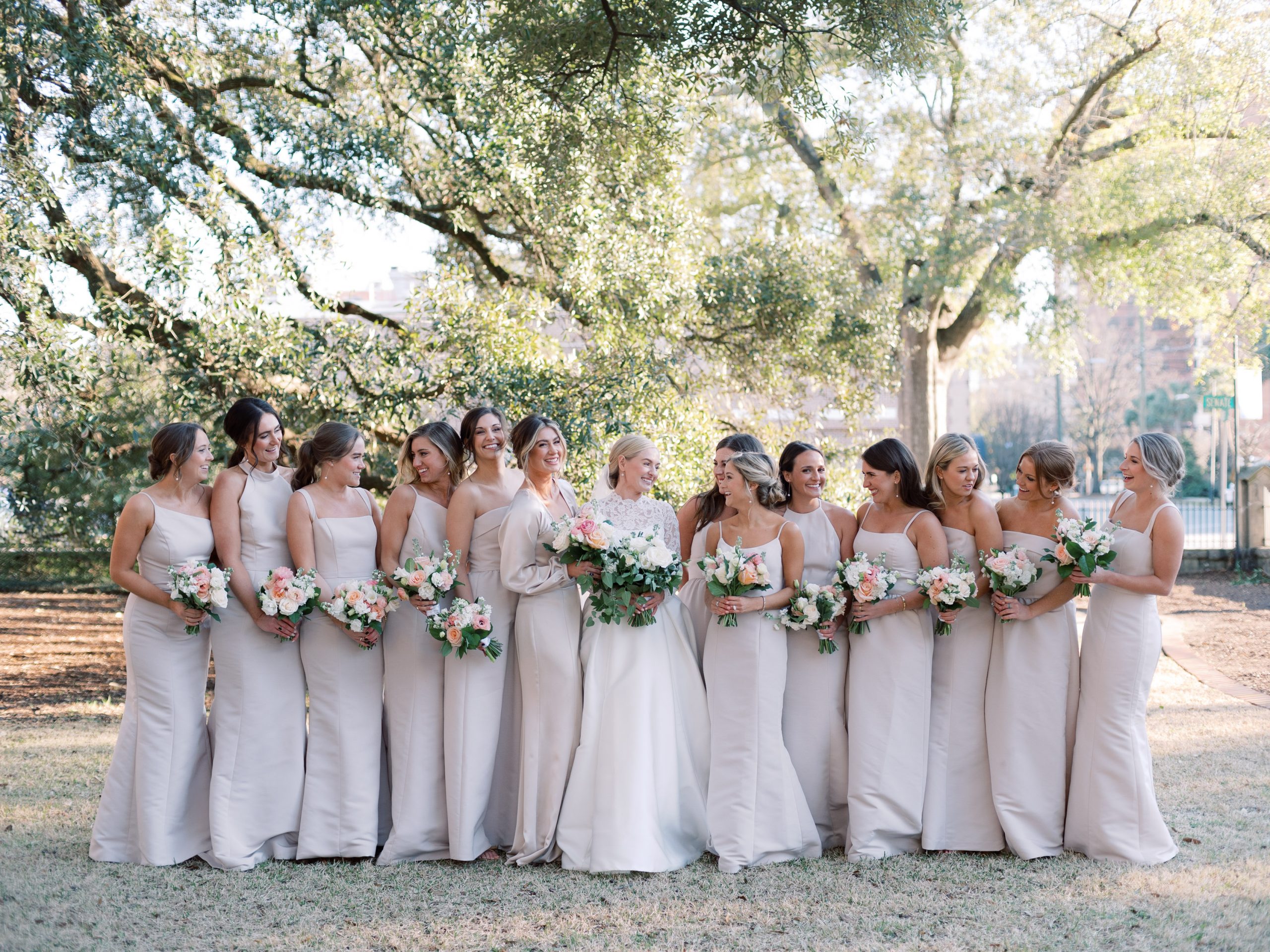 Bridesmaids joined Meg in the courtyard of Trinity Episcopal Cathedral carrying lovely bouquets including pink roses, white stock, and peach ranunculus. Anne Townsend Wakefield, Lauren McCorquodale, Ida Bland, Caroline Sewell, Paige Bryant, maid-of-honor Kate Evans, Meg Evans Bates, Allie Roper, Liz Holcomb, Ari DeLucy, Grayson Stribling, Mary Collins, Cameron Smith, Anna Orlandini. 