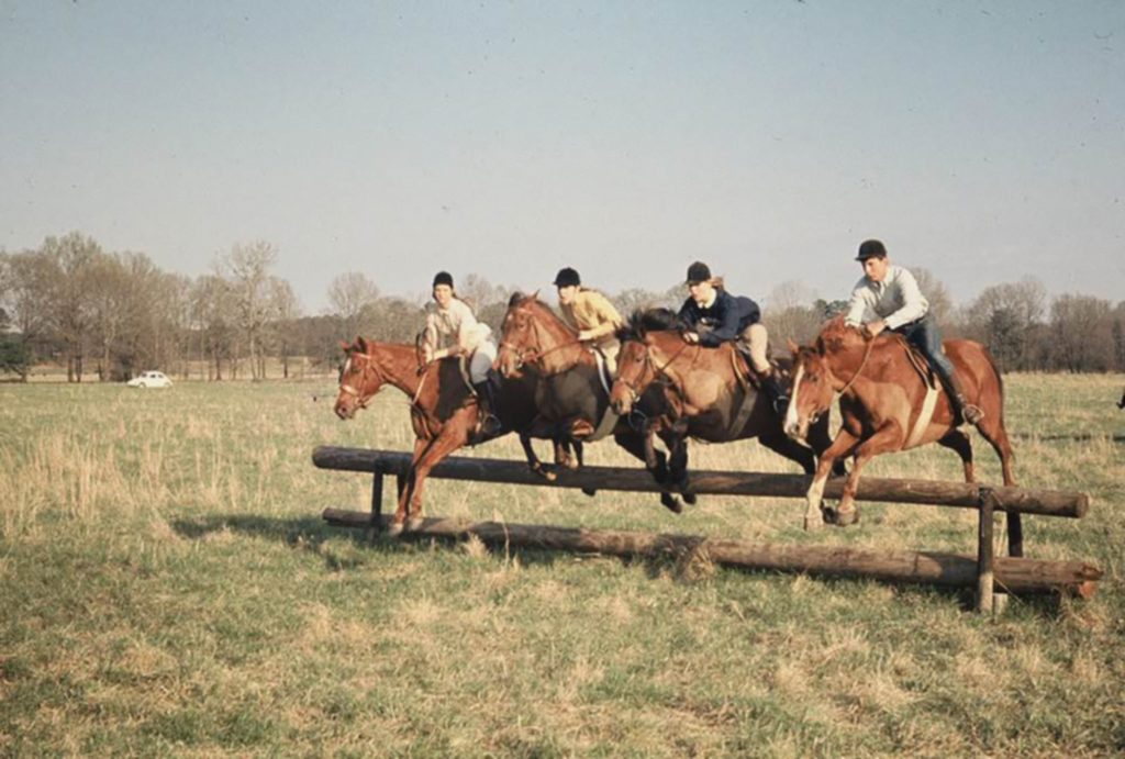 Sinkler Manning at Belle Grove trained riders and their horses to take jumps abreast in as large as eight horse-and-rider pairs. “The Bluff,” circa 1970. 
