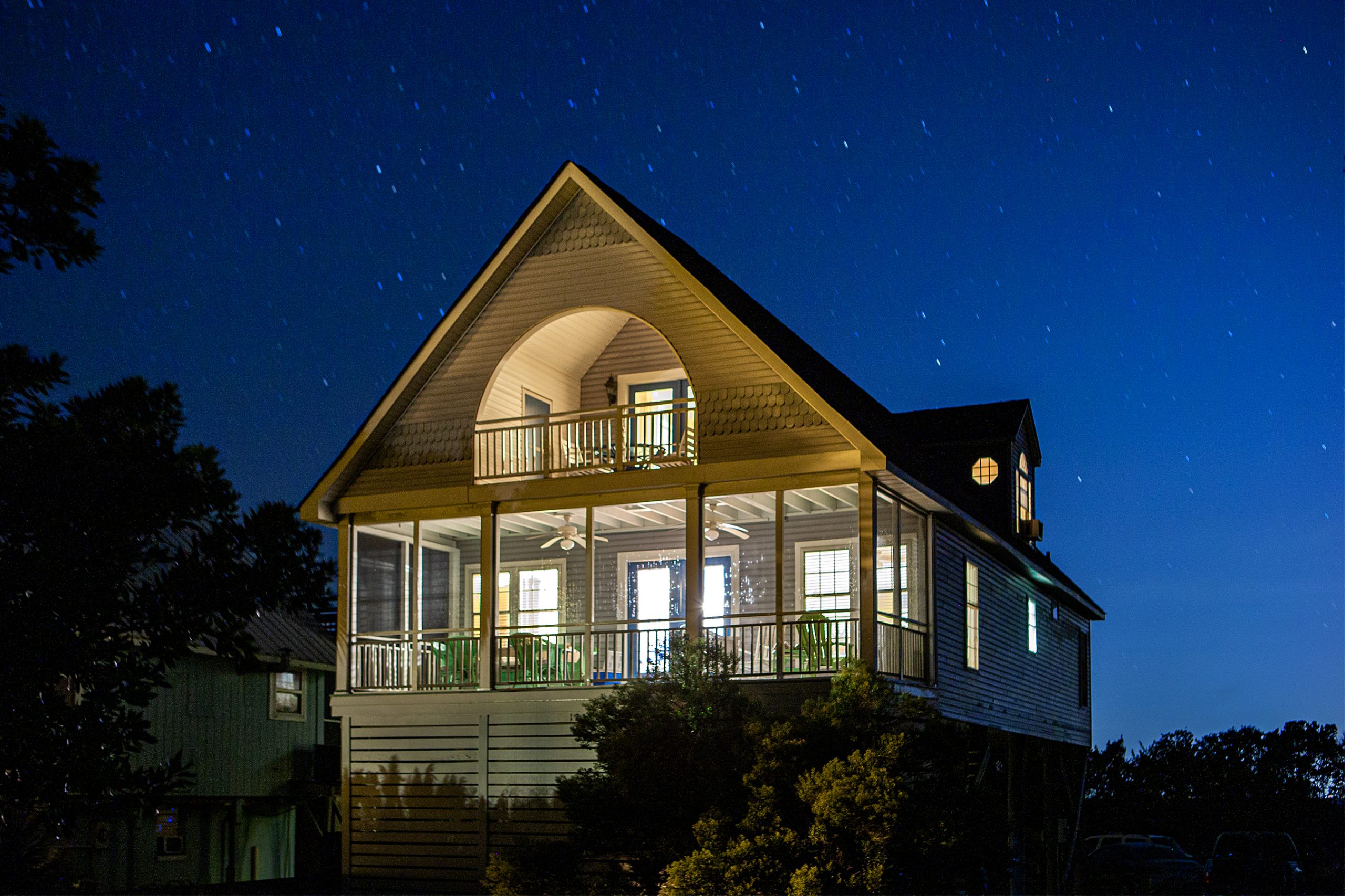 House lights burn bright on a starry night at Folly. As lights go out, windows open to hear the nearby surf wash — the best white noise for getting a great night’s sleep. 
