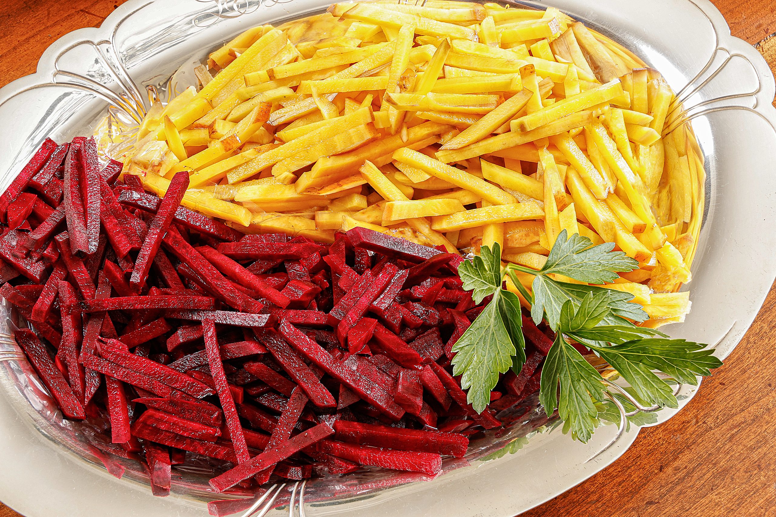 Julienne the red and yellow beets into matchsticks and keep them separate so they do not dye each other.