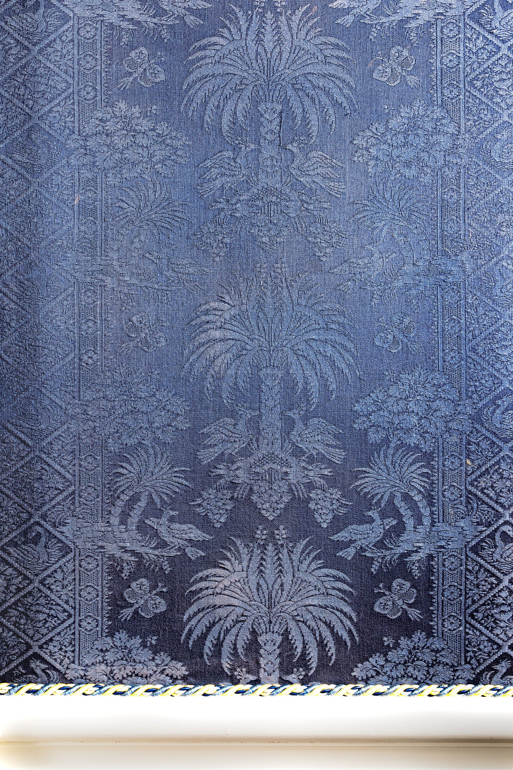  The State Dining Room walls are covered in fabric patterned with subtle palmetto trees, custom dyed a deep blue to match the state flag. 