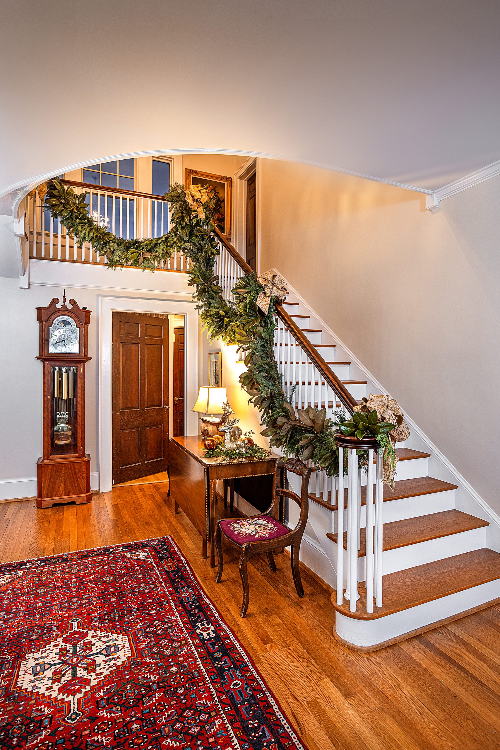  Anne remembers garland draped down the banister during the holidays when she was a child. Fresh, lush, handmade stair garland made with greenery from a local Lexington farm is decorated with hand tied bows, courtesy of the team at Cricket Newman Designs.