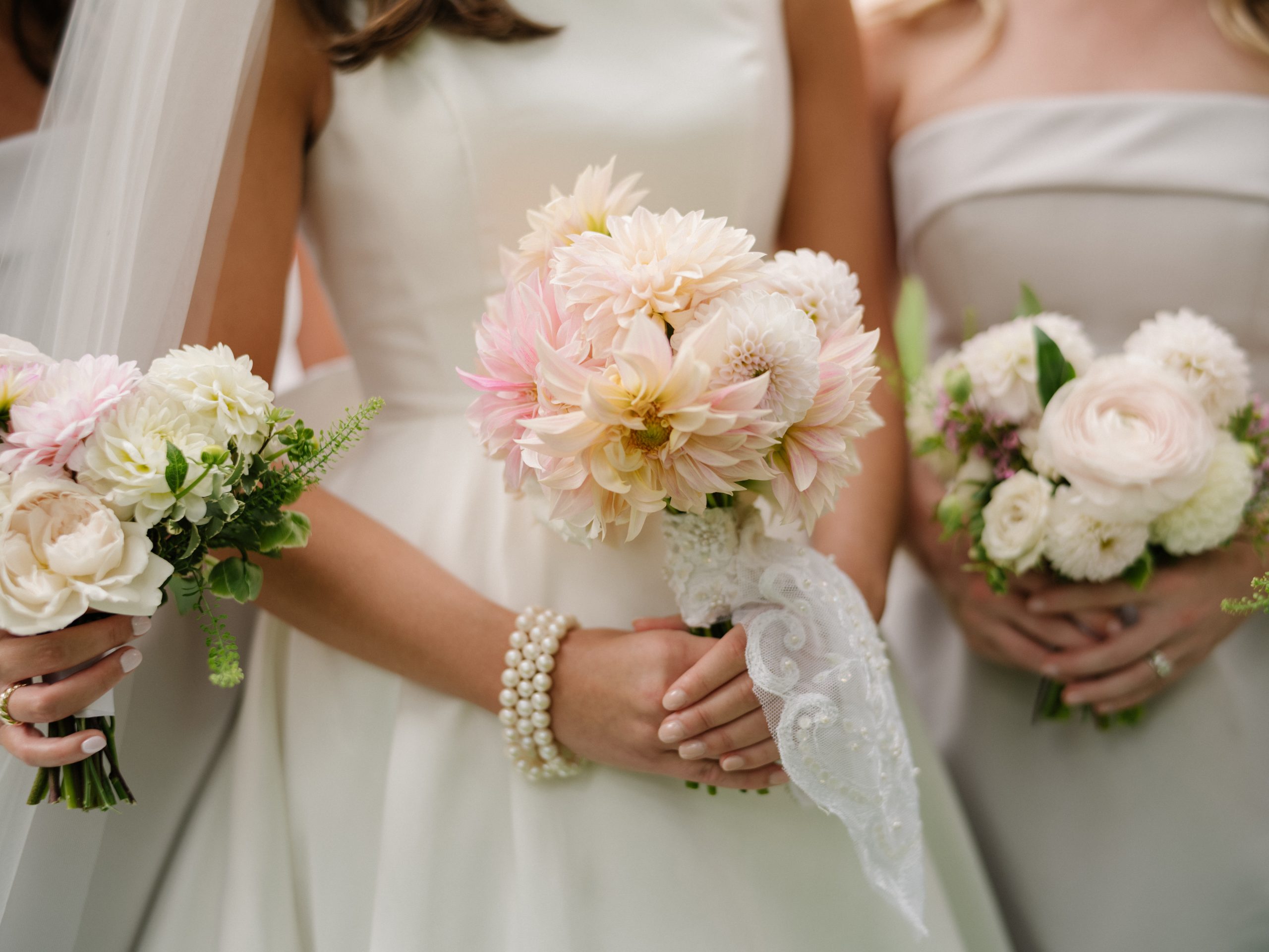 Paige carried a bouquet of dahlias, the bottom of which was wrapped with a piece of lace from the sleeve of her mother’s wedding dress she wore when she married Steve Bryant, more than 35 years ago. 
