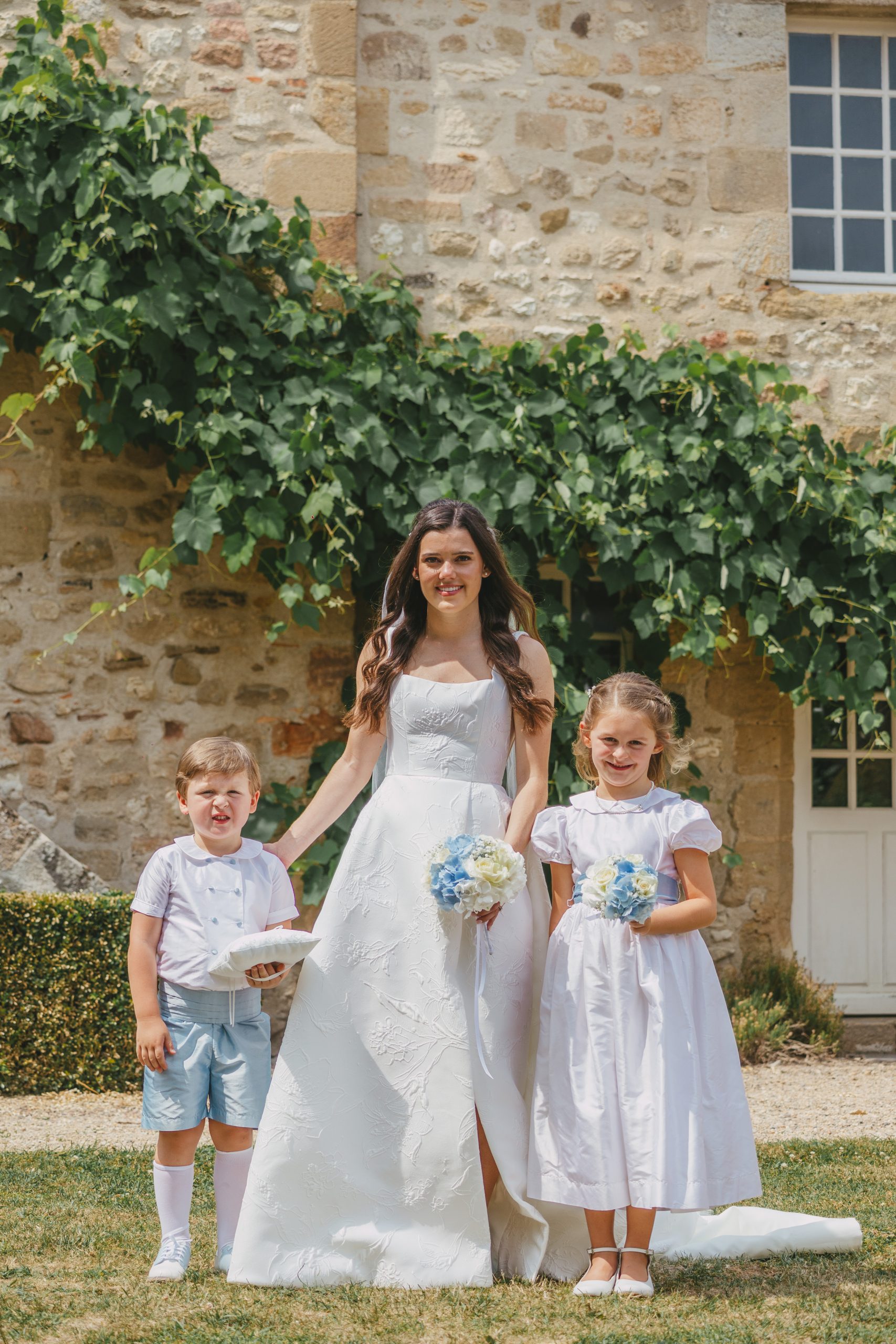 Frances looks stunning in her white silk Anne Barge gown, joined by ringbearer Marks King and flower girl Margaret King, cousins of the bride. 