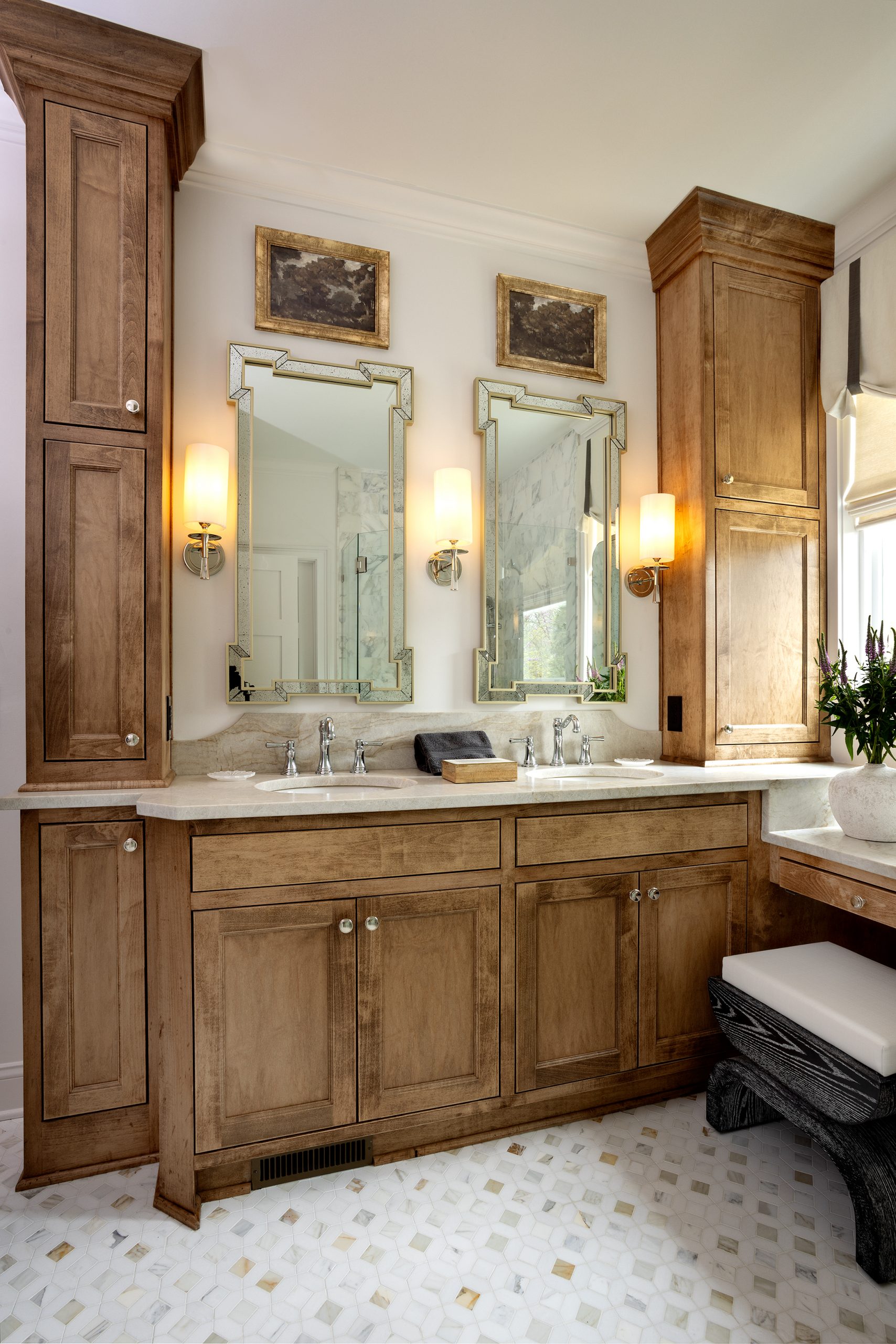 Combined with exquisite tile, beautiful mirrors, lighting, and art, the bathroom is perfect for the Palmers, complete with all of Kelly’s wishes: a tub, shower, makeup vanity, double sink, and floor-to-ceiling storage. 