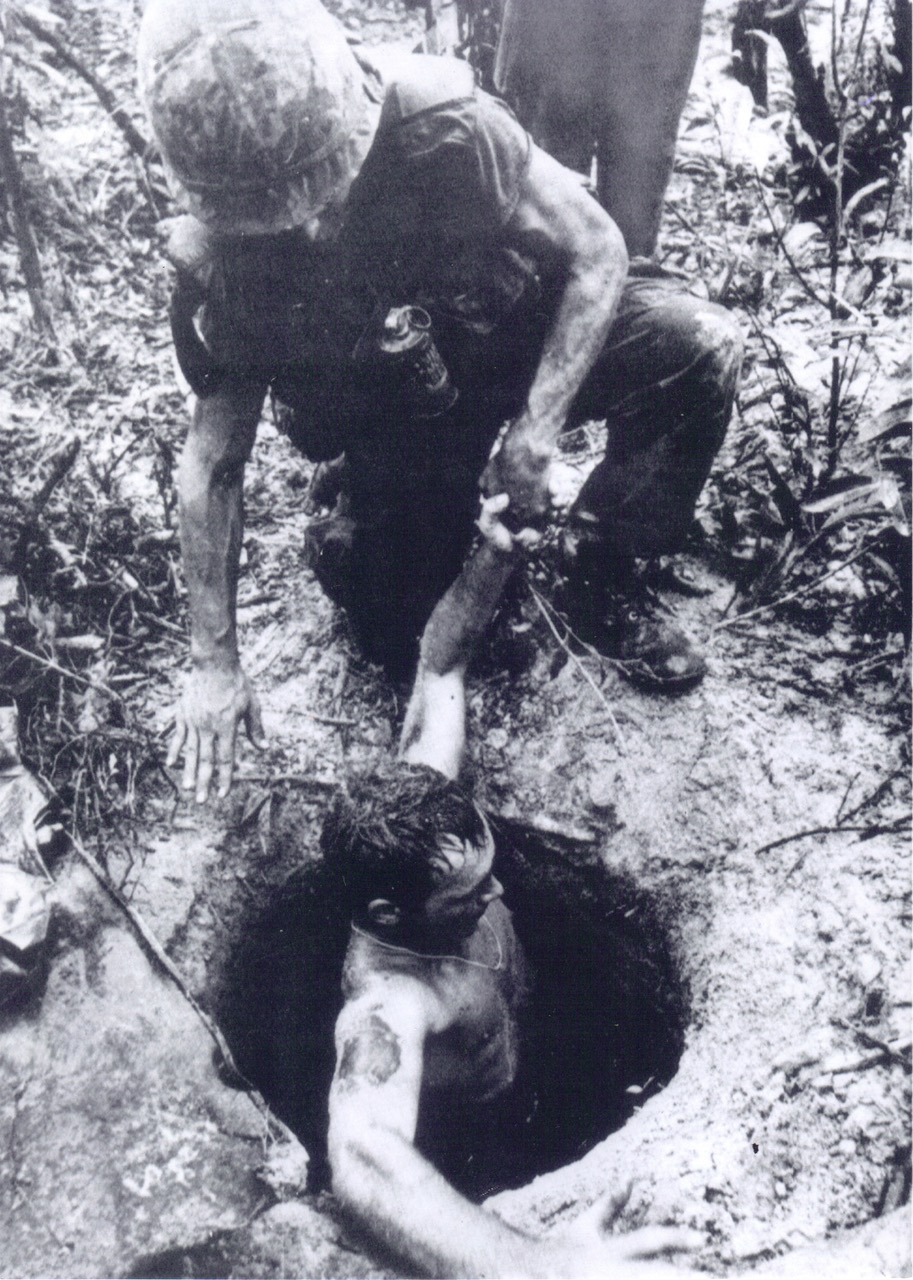 C.W. Bowman is helped out of a tunnel.